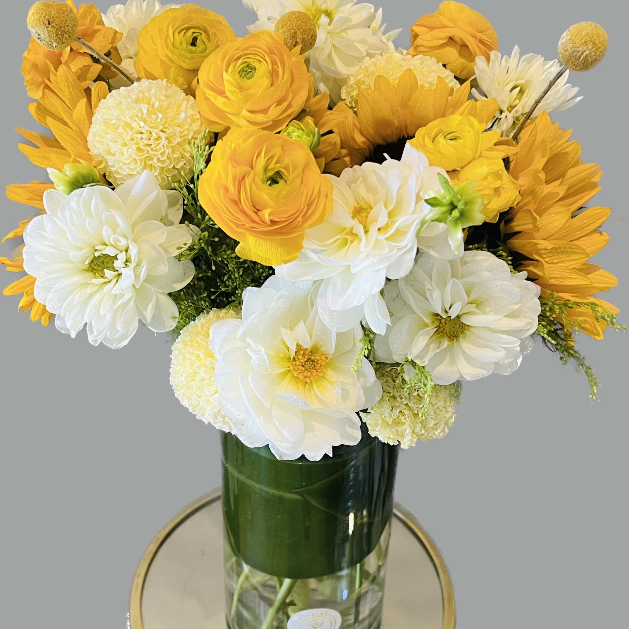 Yellow and white bouquet in a glass vase