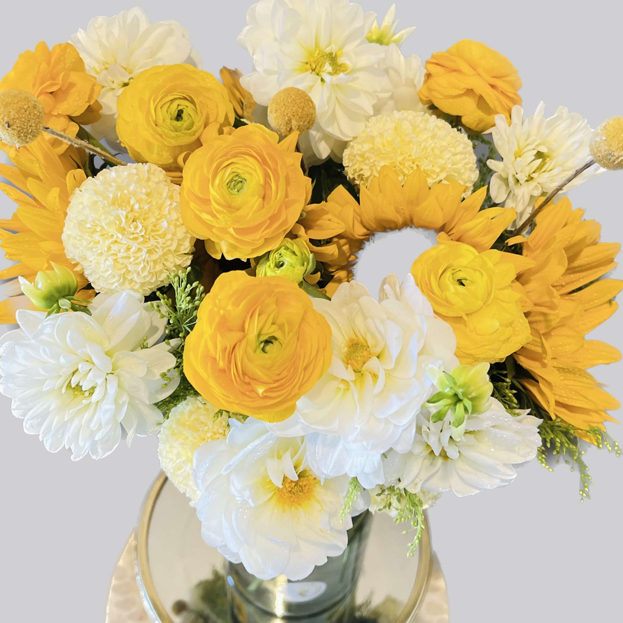 Yellow and white mixed bouquet in a glass vase