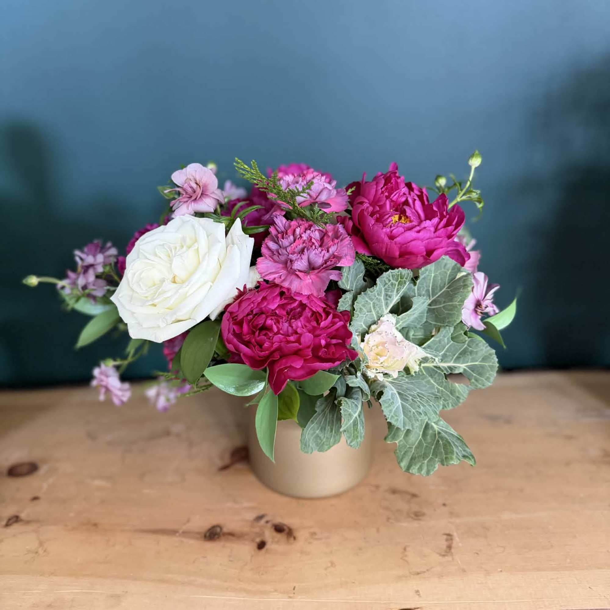 A lush, romantic arrangement featuring rich raspberry and soft blush blooms, thoughtfully