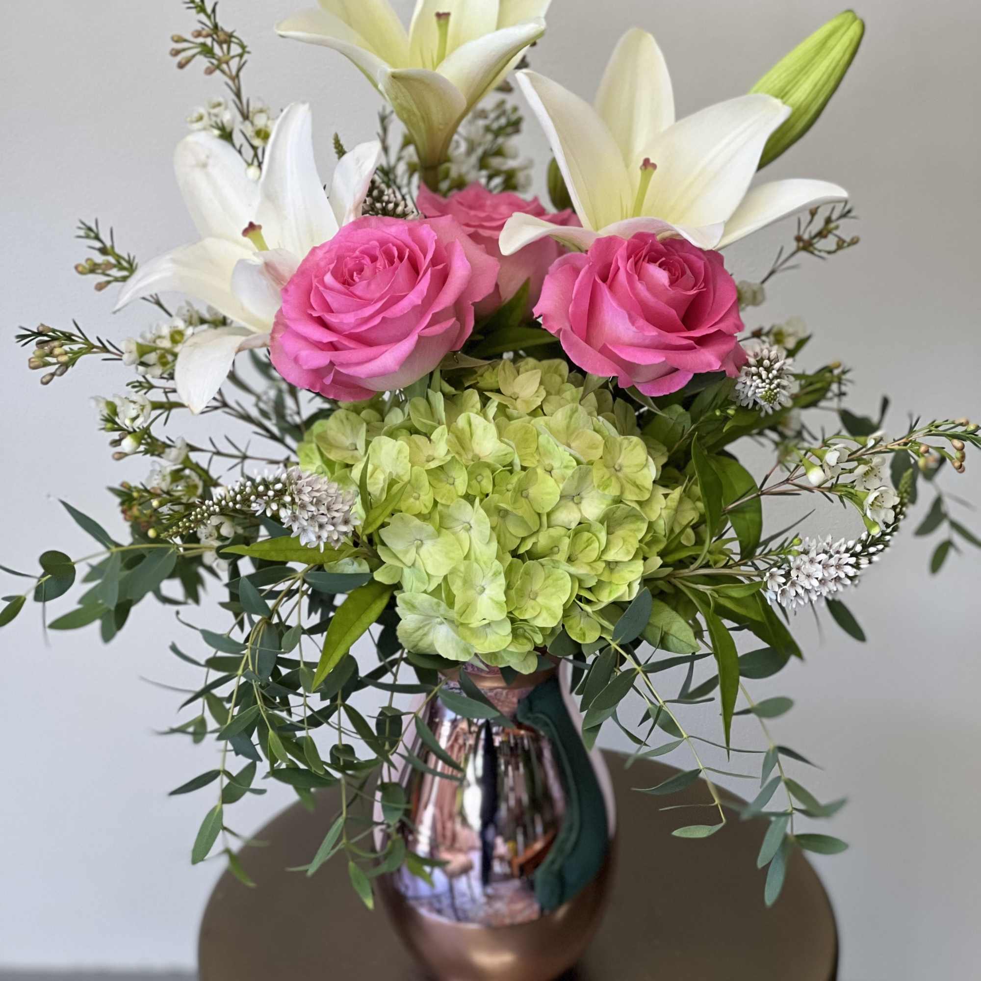 This beautiful arrangement has hydrangea, lily&rsquo;s and roses in a spectacular pink