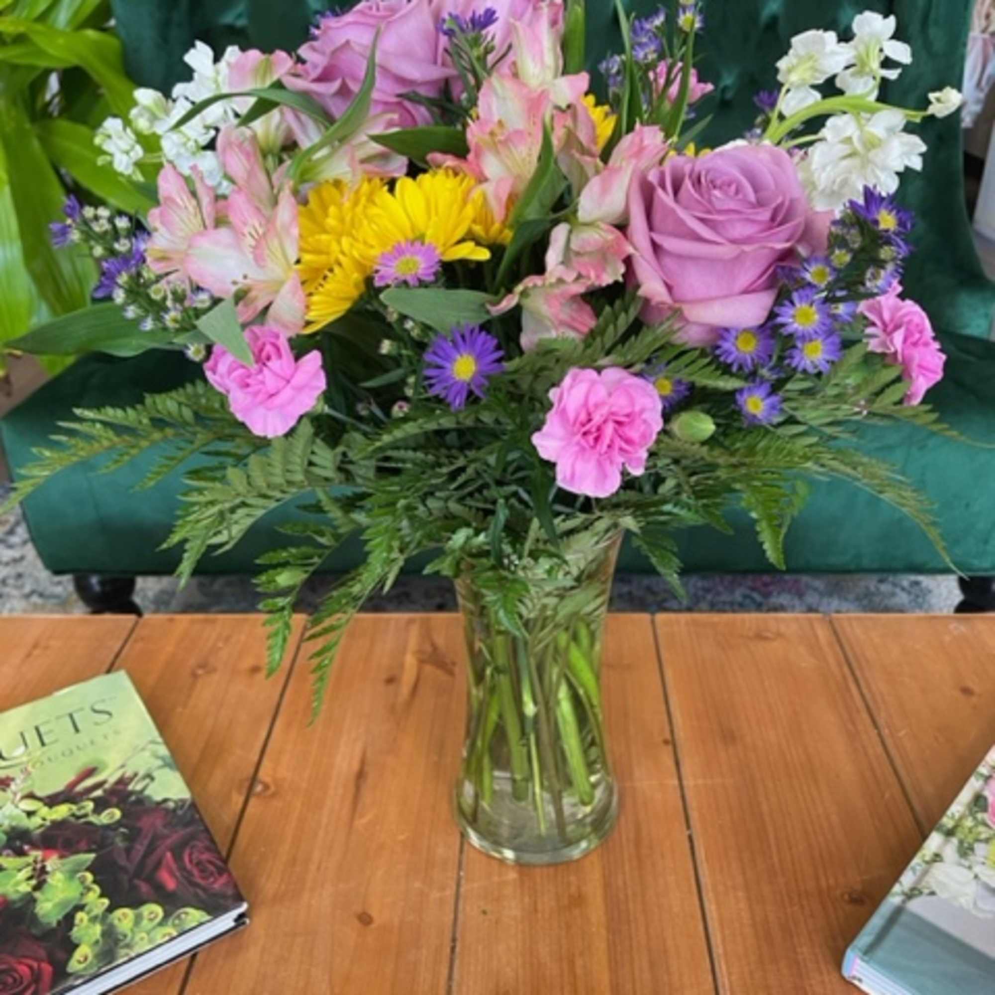 A lavender-themed arrangement featuring roses, daisies, alstroemerias, stock, mini carnations, and asters.