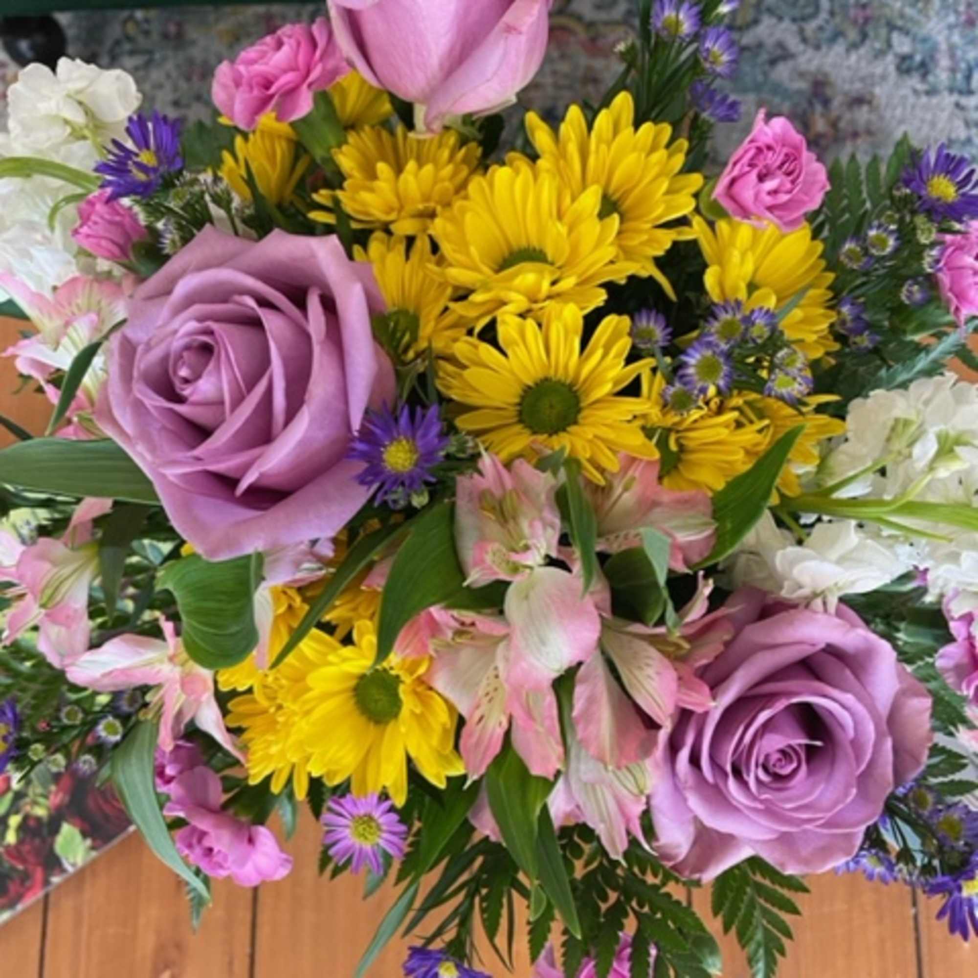 A lavender-themed arrangement featuring roses, daisies, alstroemerias, stock, mini carnations, and asters., photo 2 of 3
