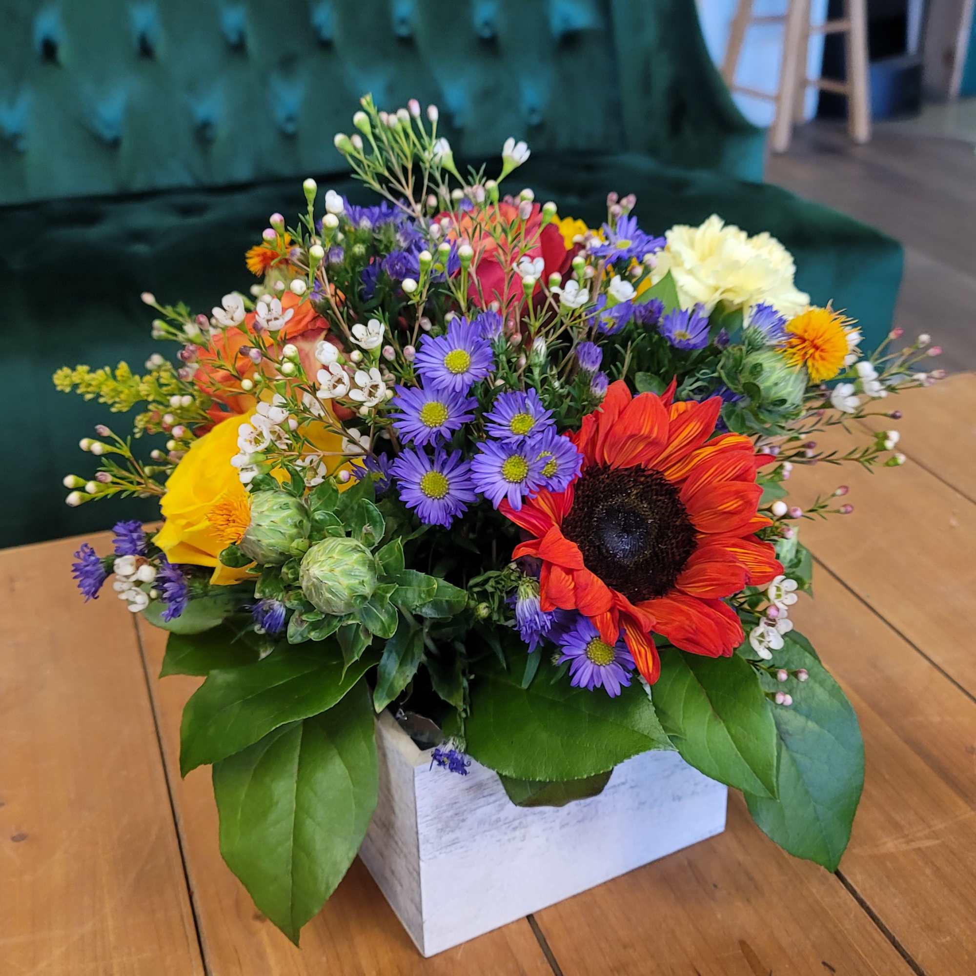 Colorful mixed flower arrangement in a white box