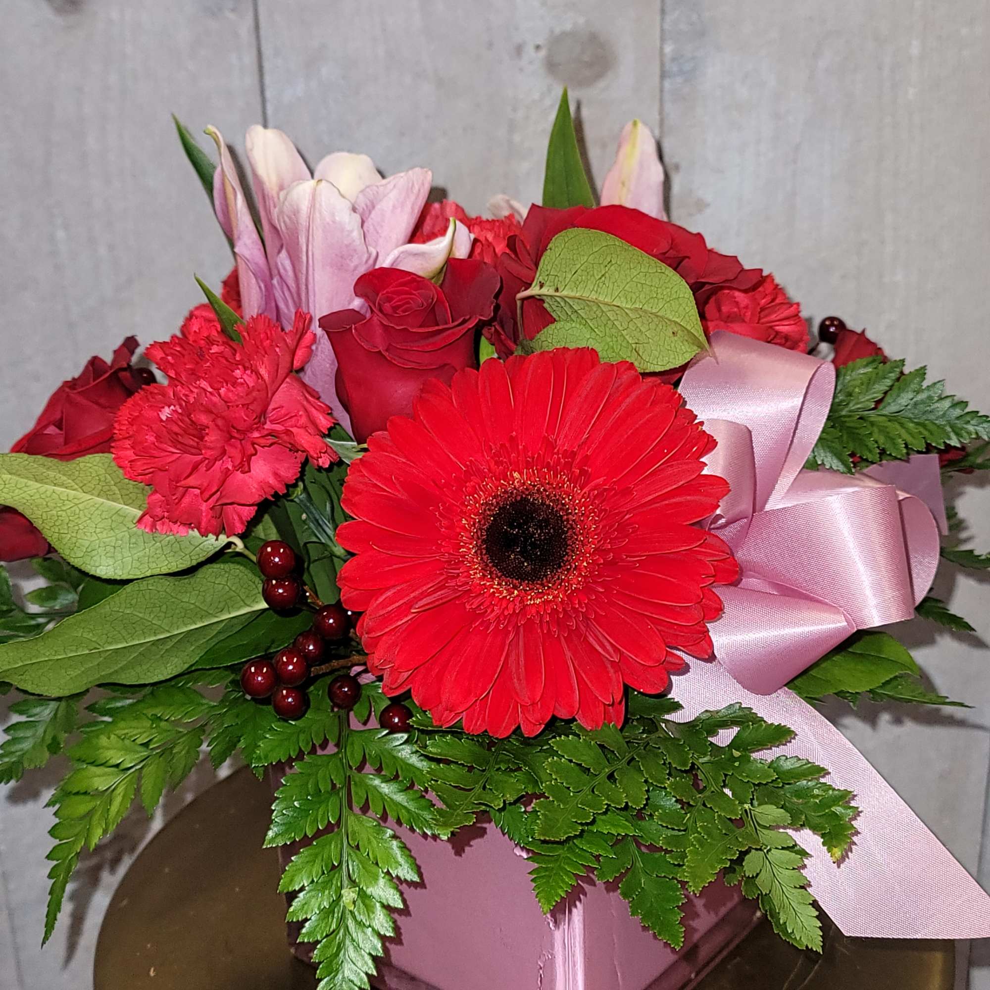 Roses, Oriental lilies, Gerber Daisy, and Carnations in a square vase
