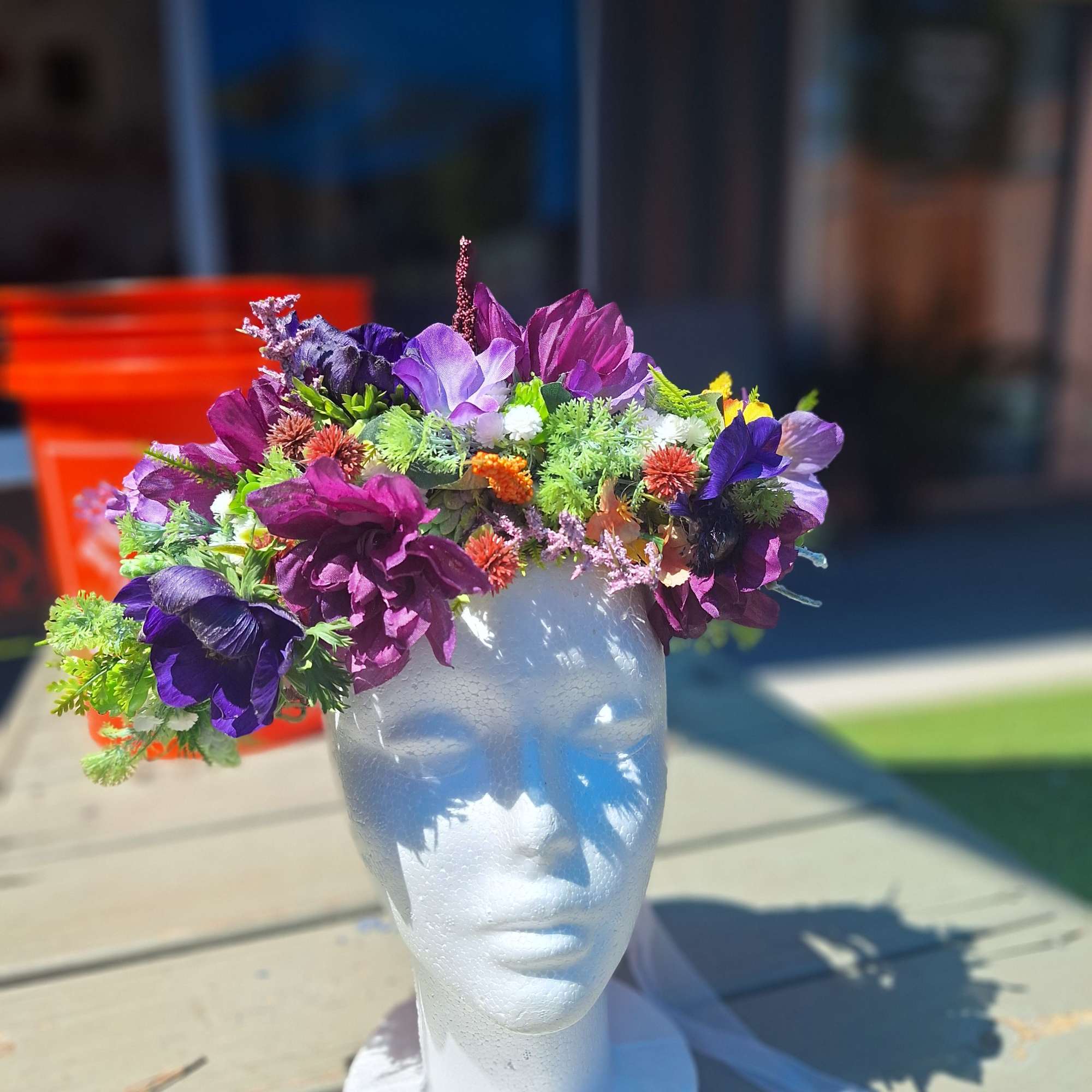 Purple floral crown on a white mannequin head