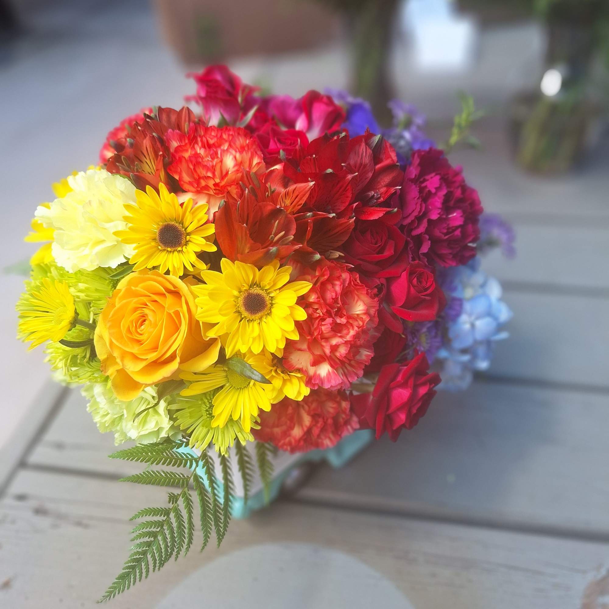 Bright mixed bouquet with roses, daisies, and carnations