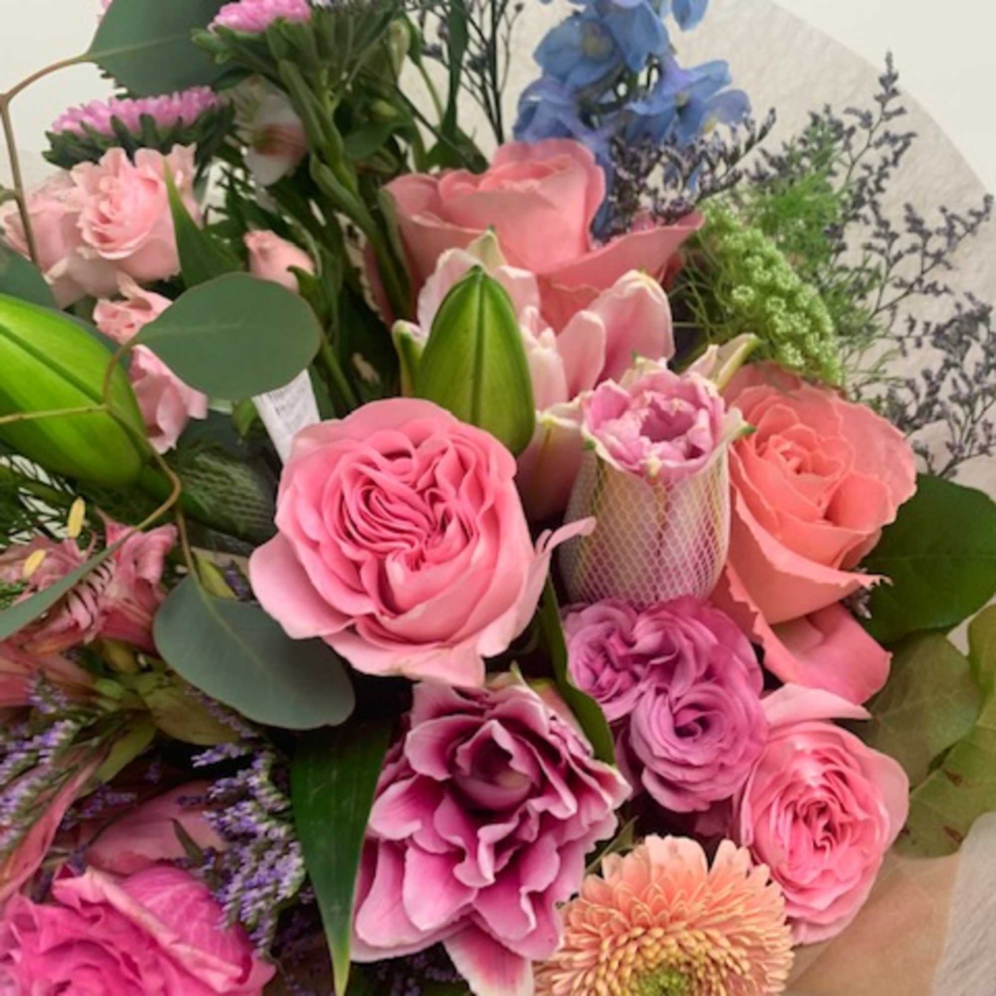 Bouquet of pink and purple flowers with green foliage