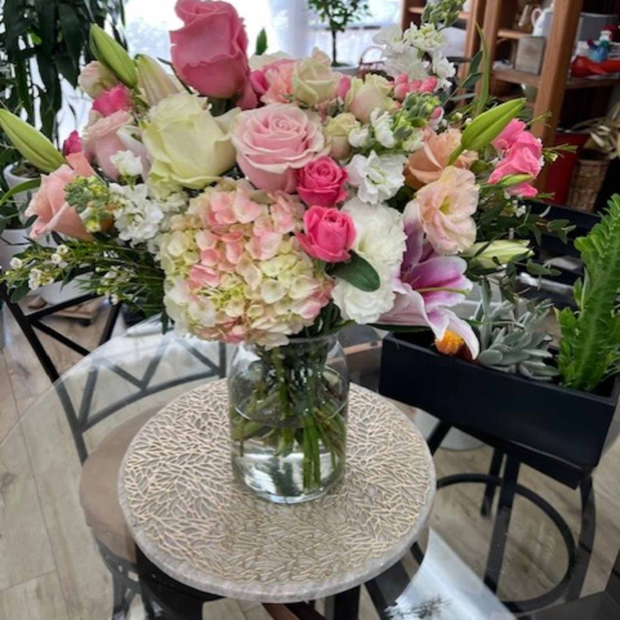 Pink and white mixed bouquet in a clear glass vase