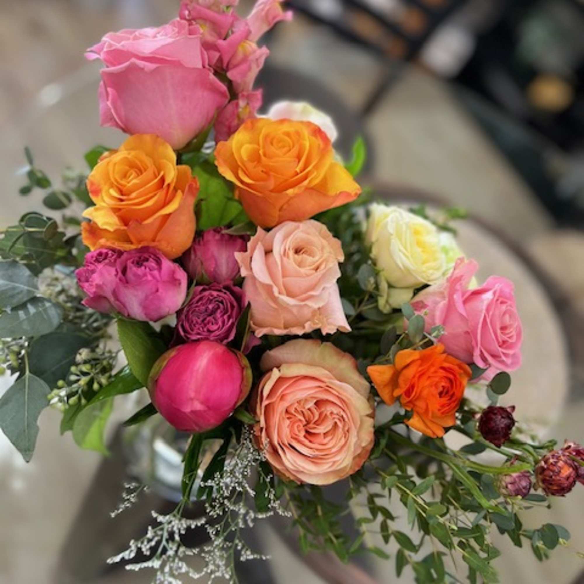 Bouquet of multicolored roses with pink snapdragons