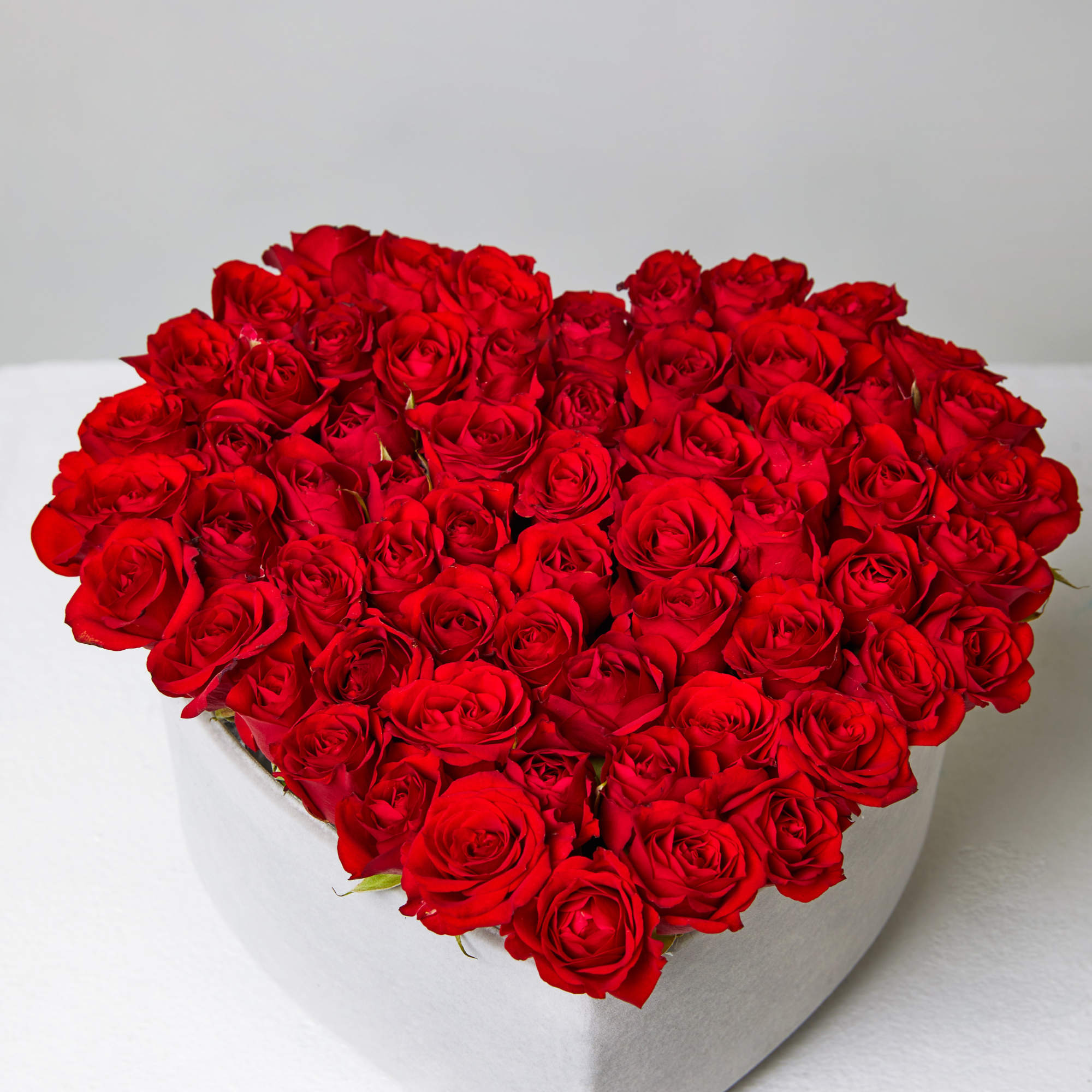 Heart-shaped box filled with red roses