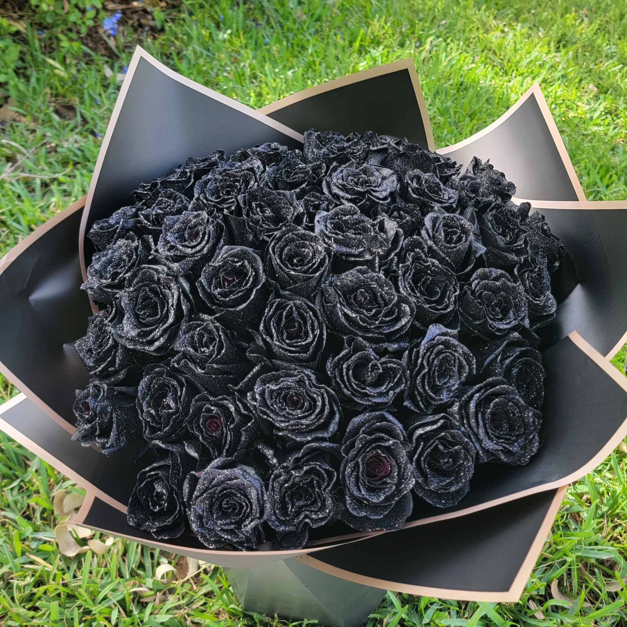 Bouquet of black roses wrapped in black paper