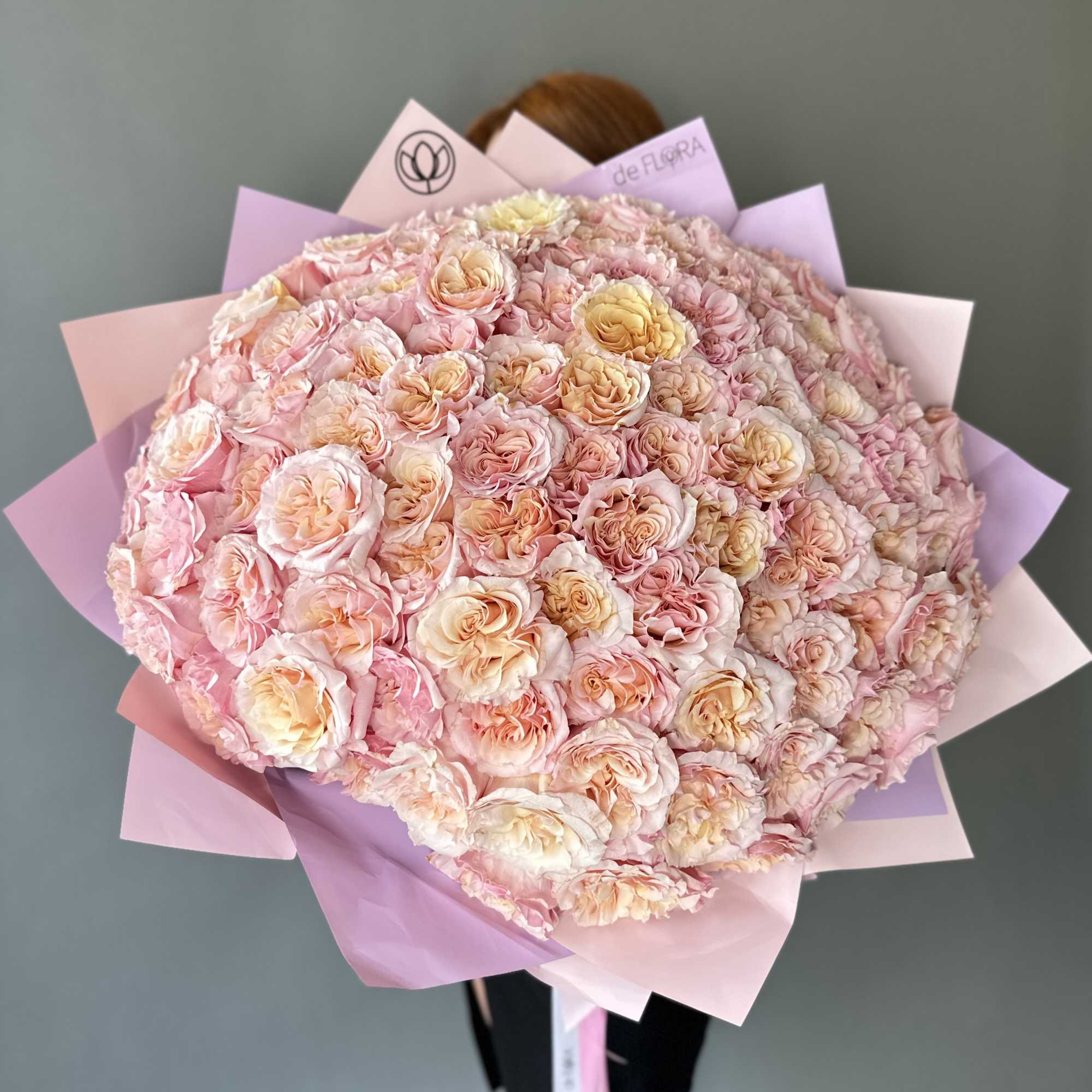 Large bouquet of pale pink and peach roses wrapped in pink paper, photo 2 of 6