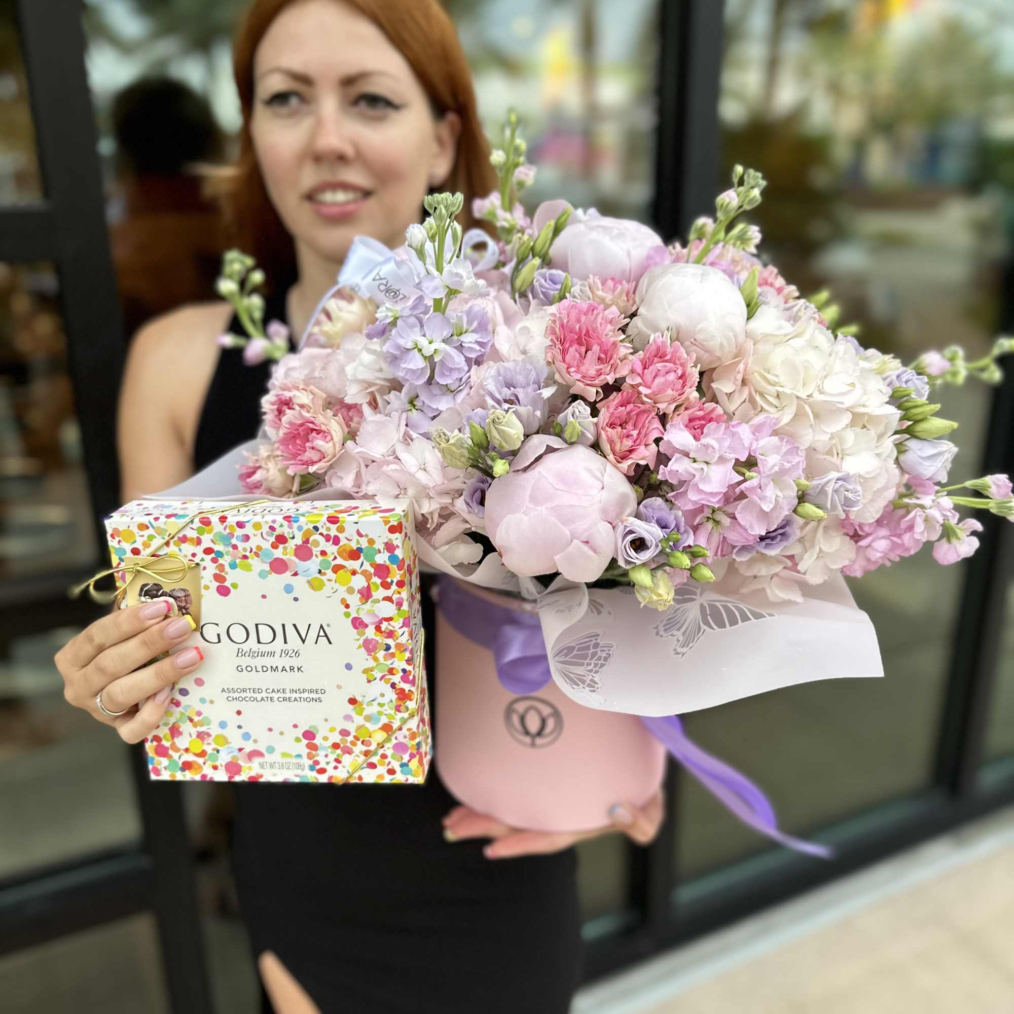 Pastel bouquet in a pink hatbox with a chocolate gift box