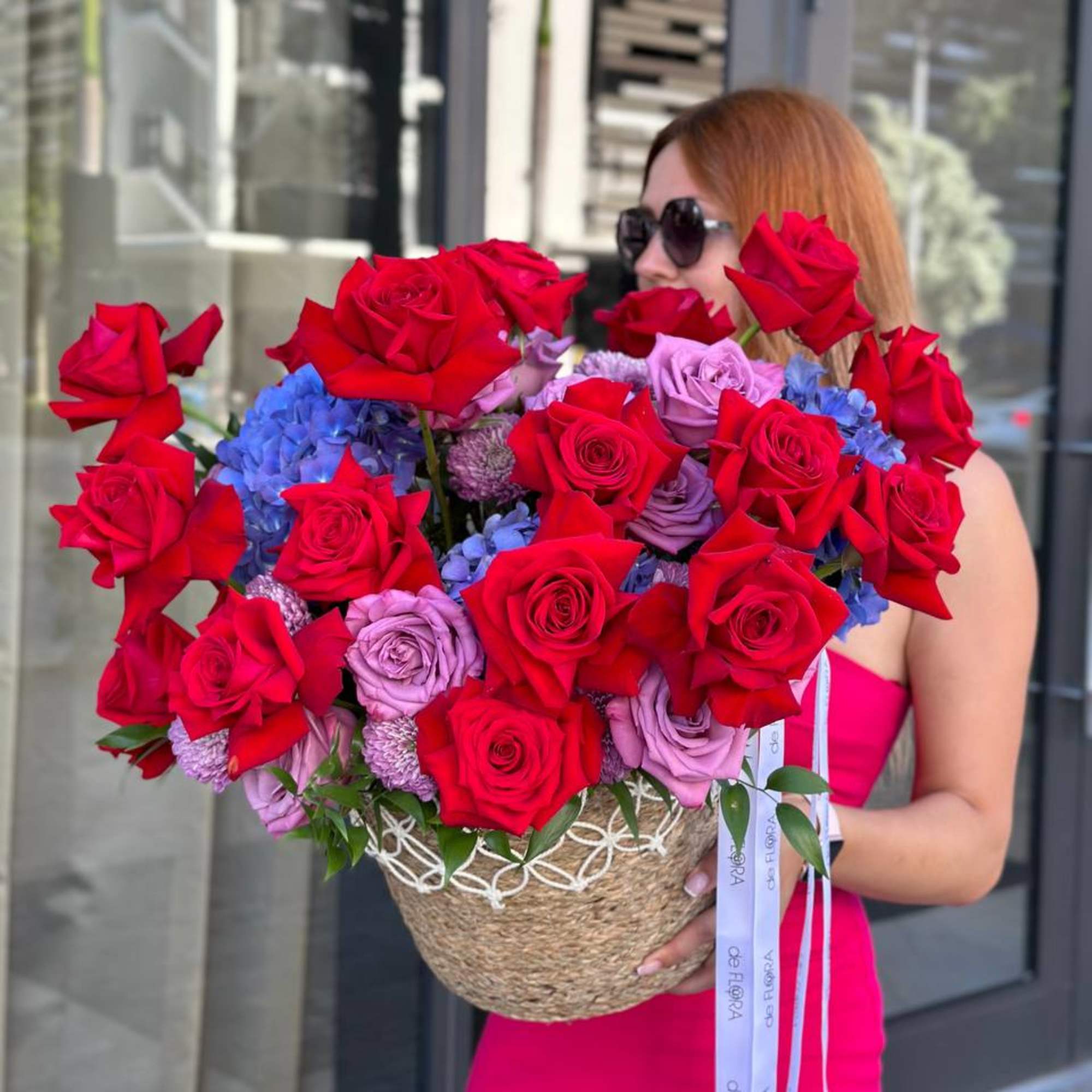 Large basket arrangement of red, lavender, and blue flowers