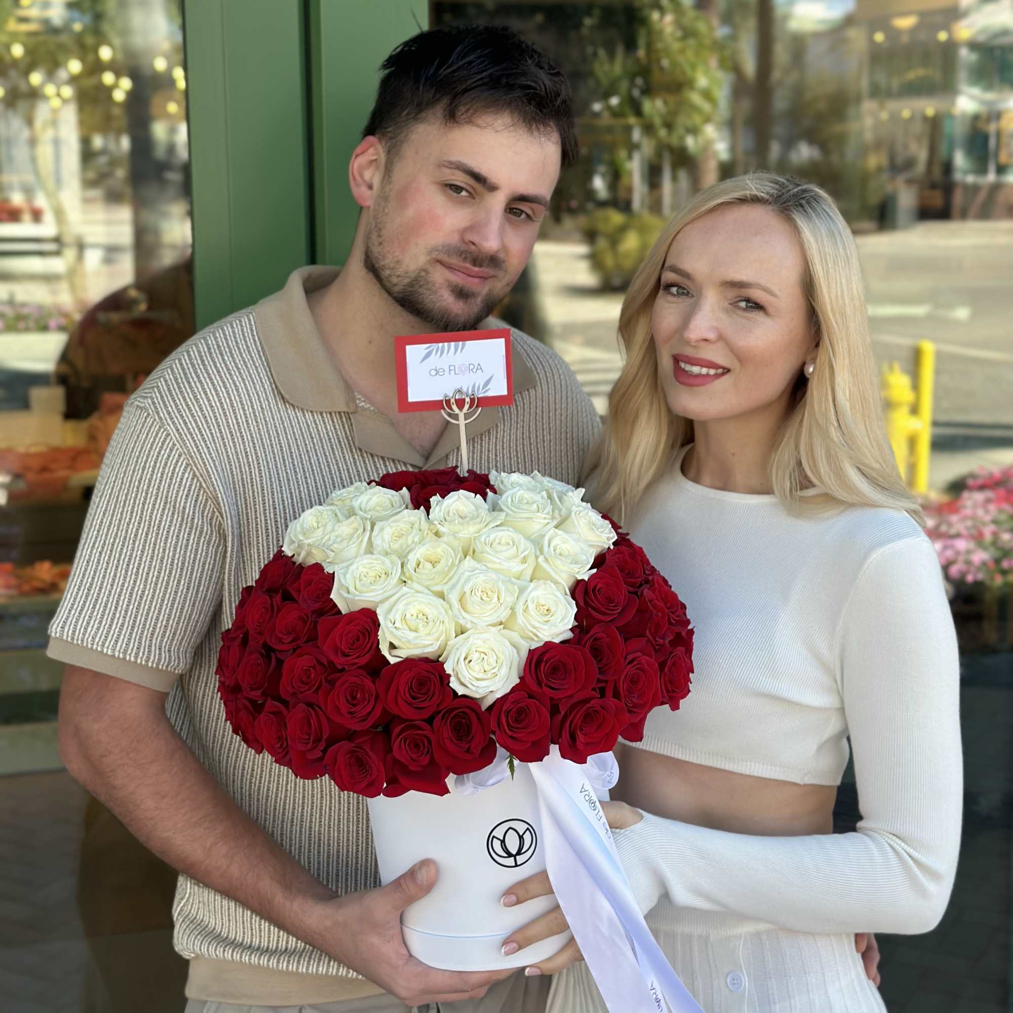 Large red and white rose arrangement in a white hatbox