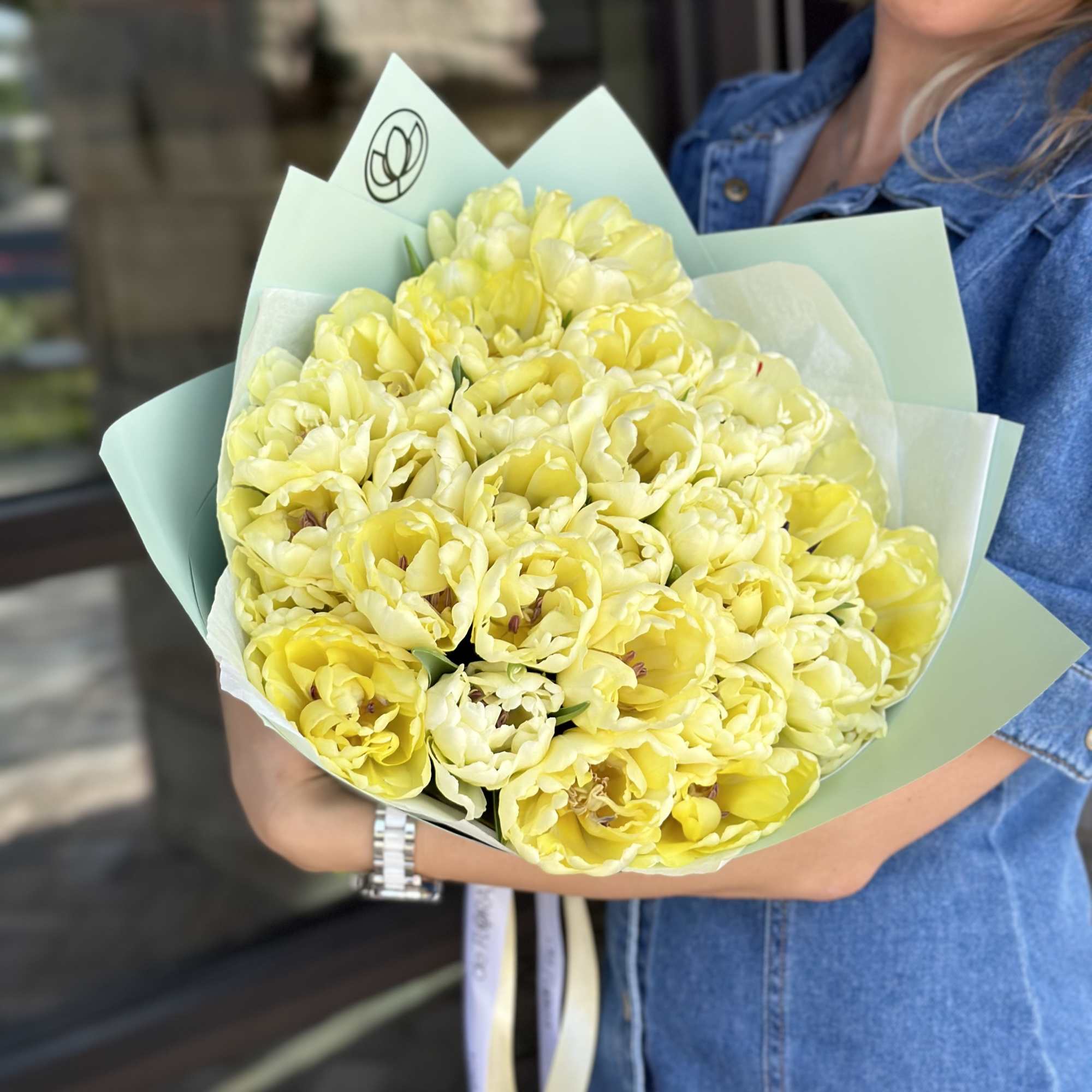 Bouquet of pale yellow tulips wrapped in light blue paper, photo 2 of 6