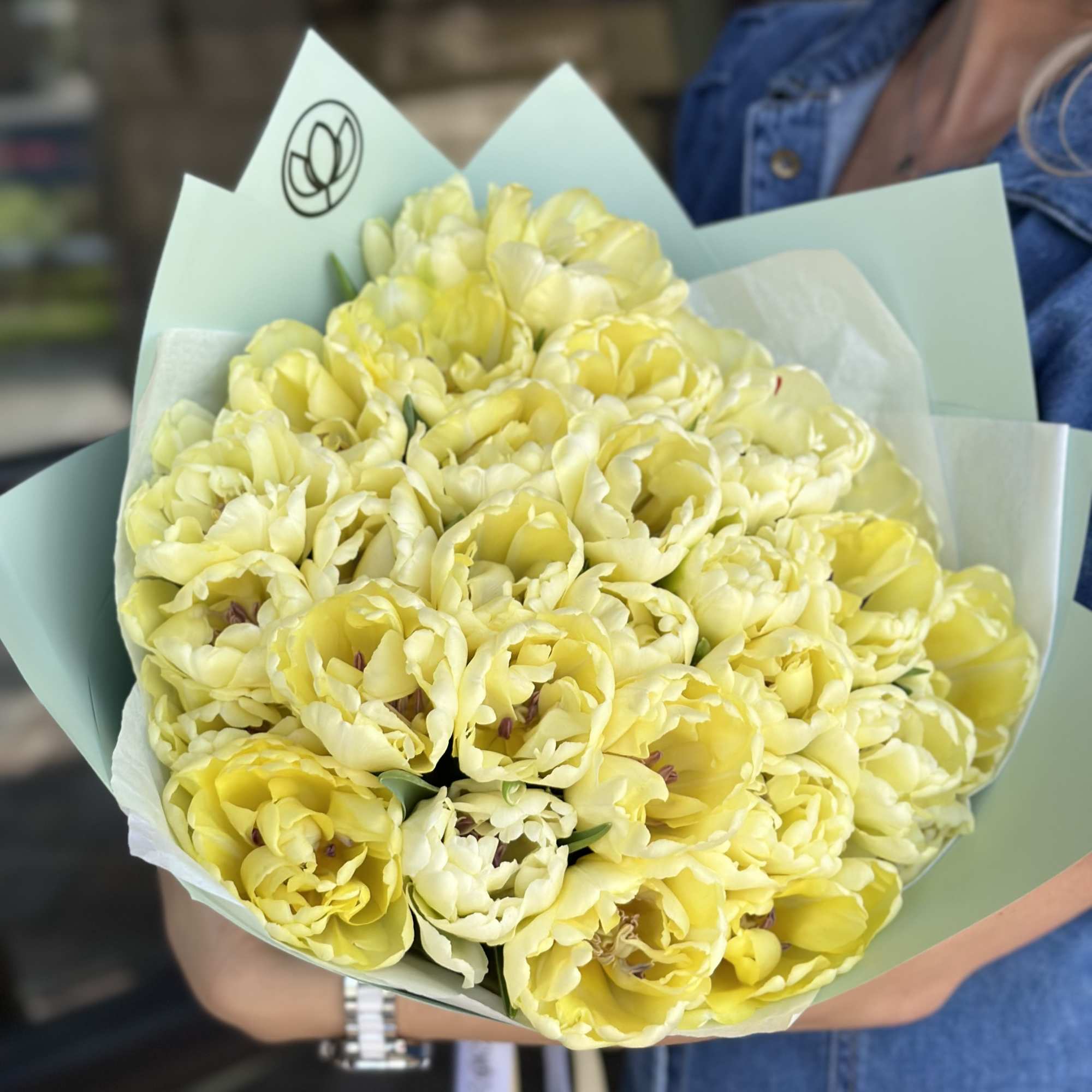 Bouquet of pale yellow tulips wrapped in light blue paper, photo 3 of 6