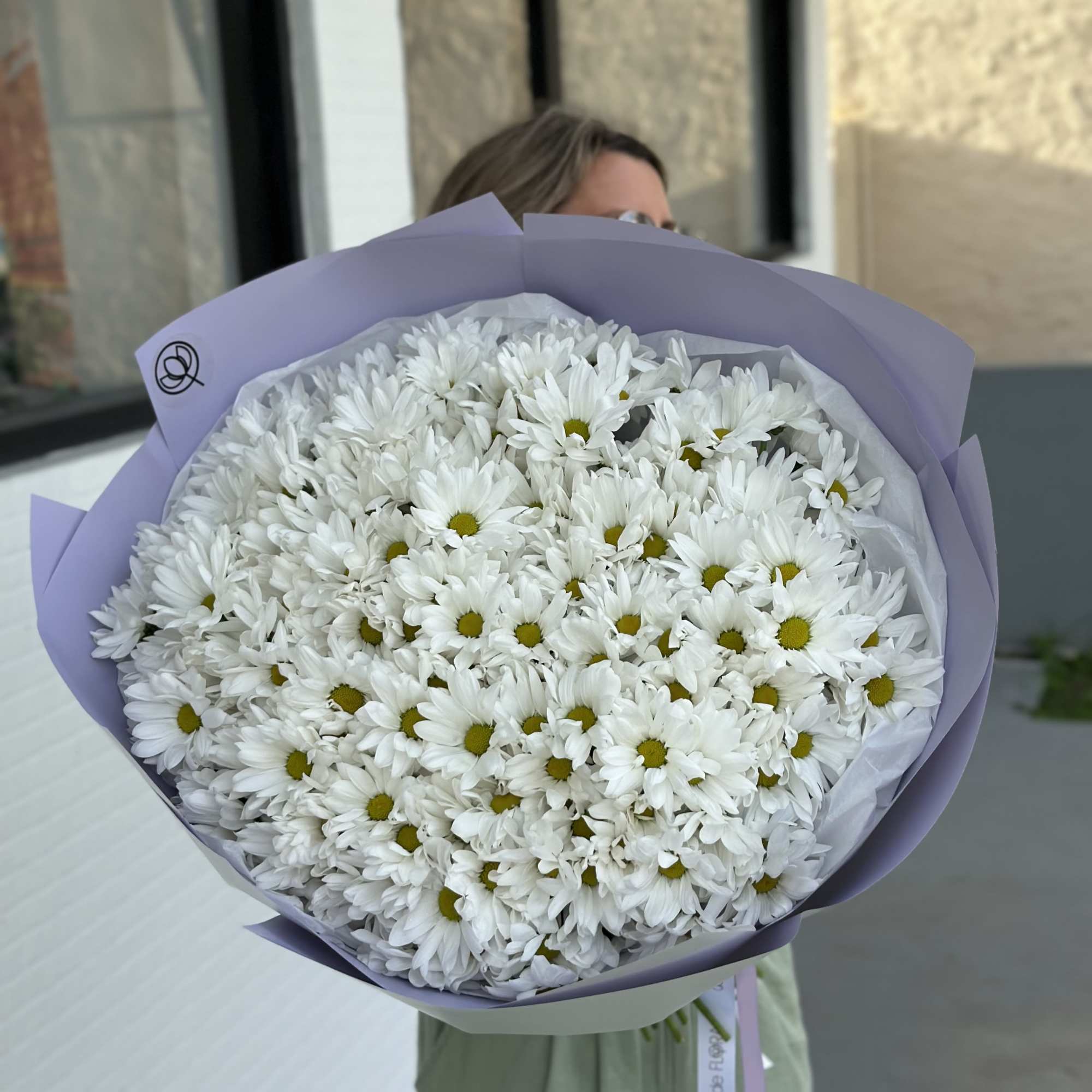Large bouquet of white daisies wrapped in lavender paper, photo 5 of 5