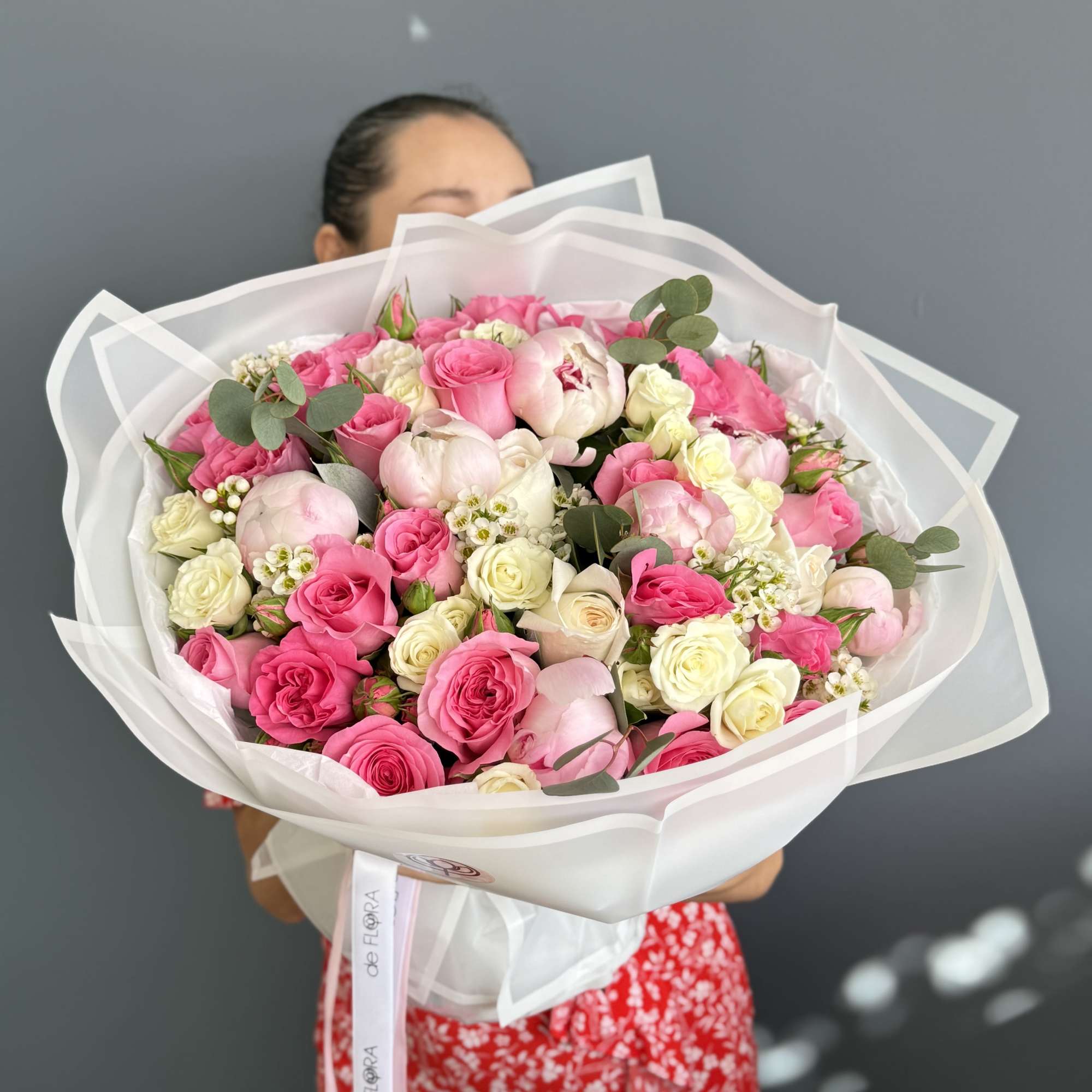 Large bouquet of pink and white roses wrapped in white paper, photo 2 of 3