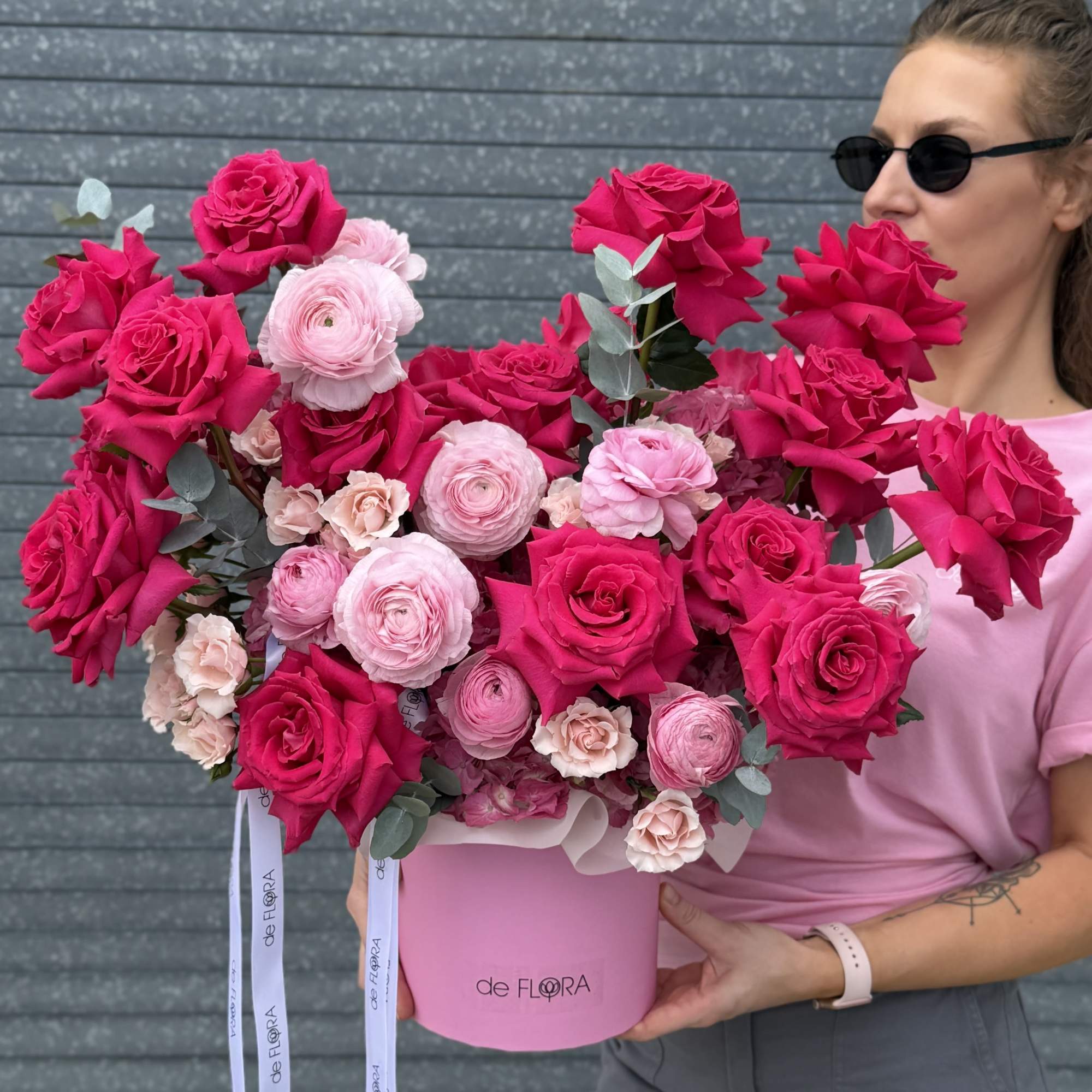 Large pink and red rose arrangement in a pink hat box