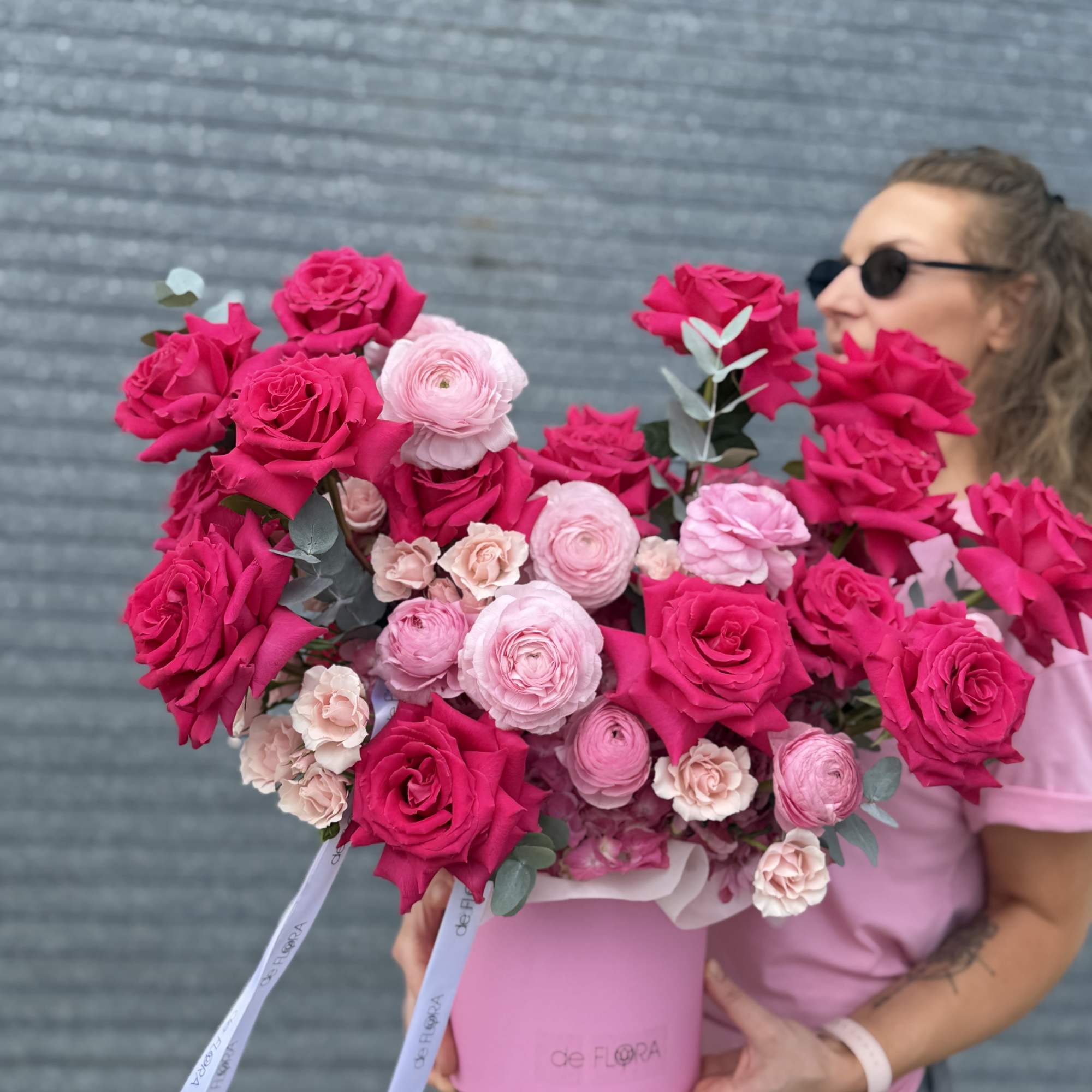 Large pink rose and ranunculus bouquet in a pink hat box
