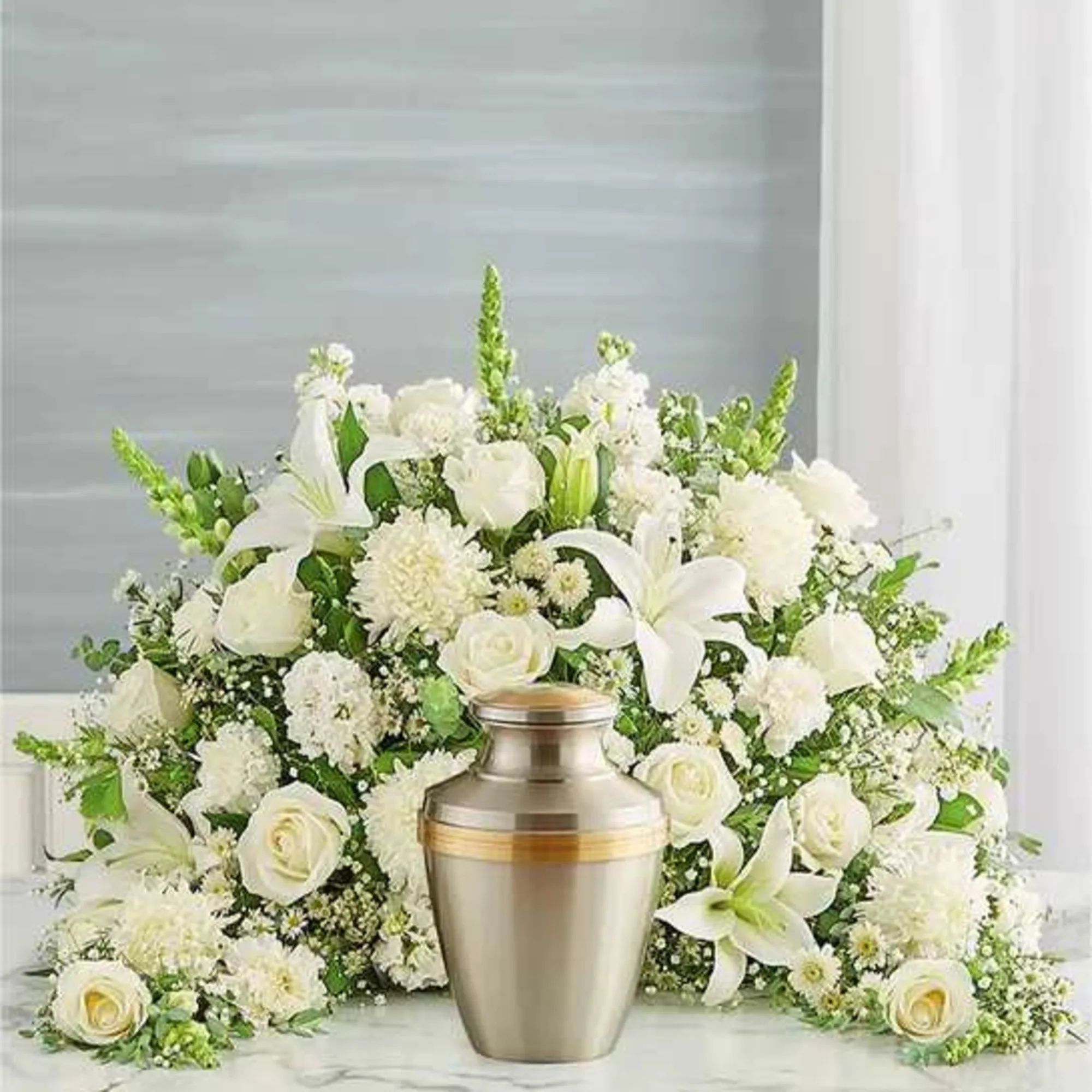 Express your heartfelt condolences with a beautiful floral tribute.One-sided arrangement of white