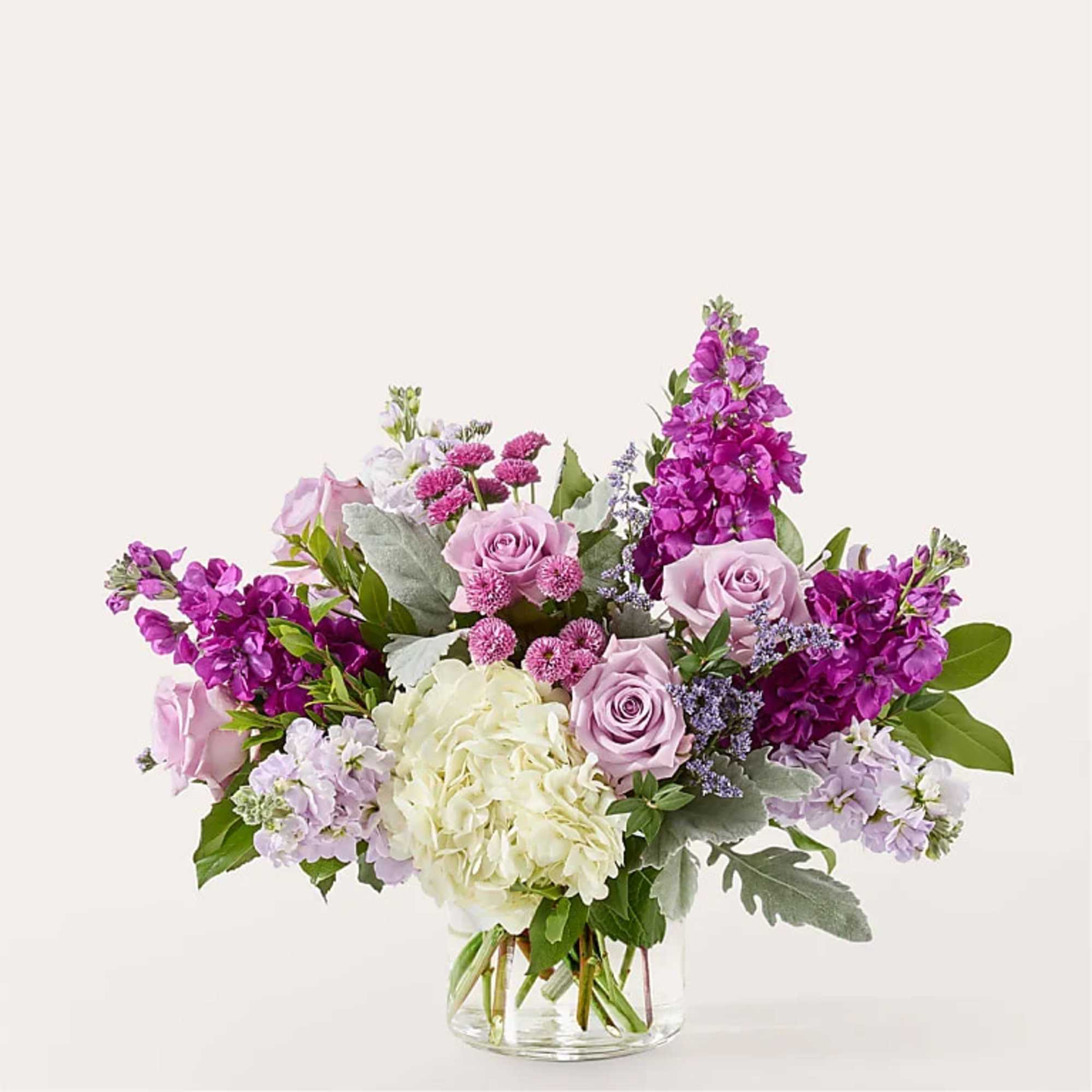 Lavender and purple floral arrangement in a clear glass vase