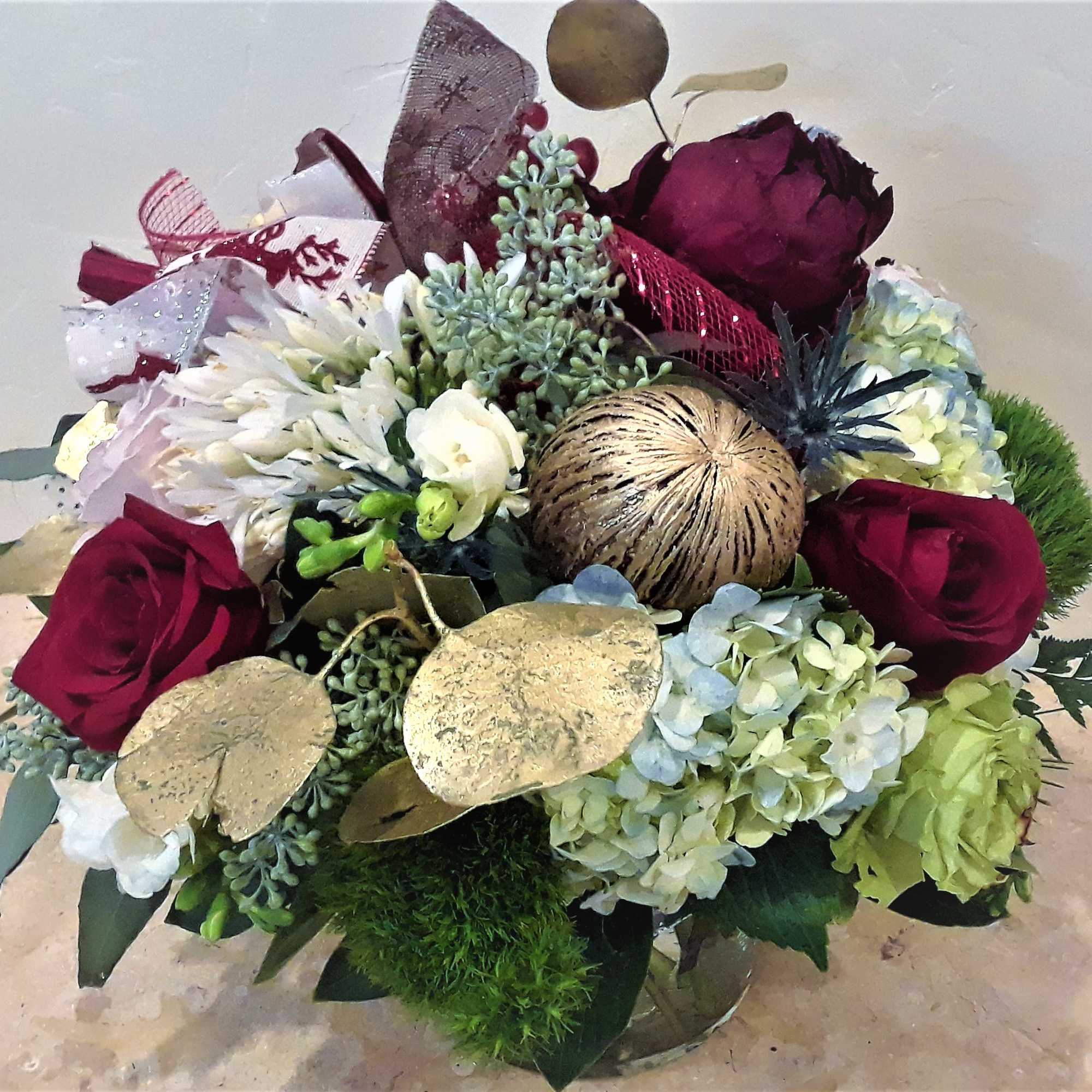 Bouquet of burgundy roses, white blooms, and hydrangeas with gold accents