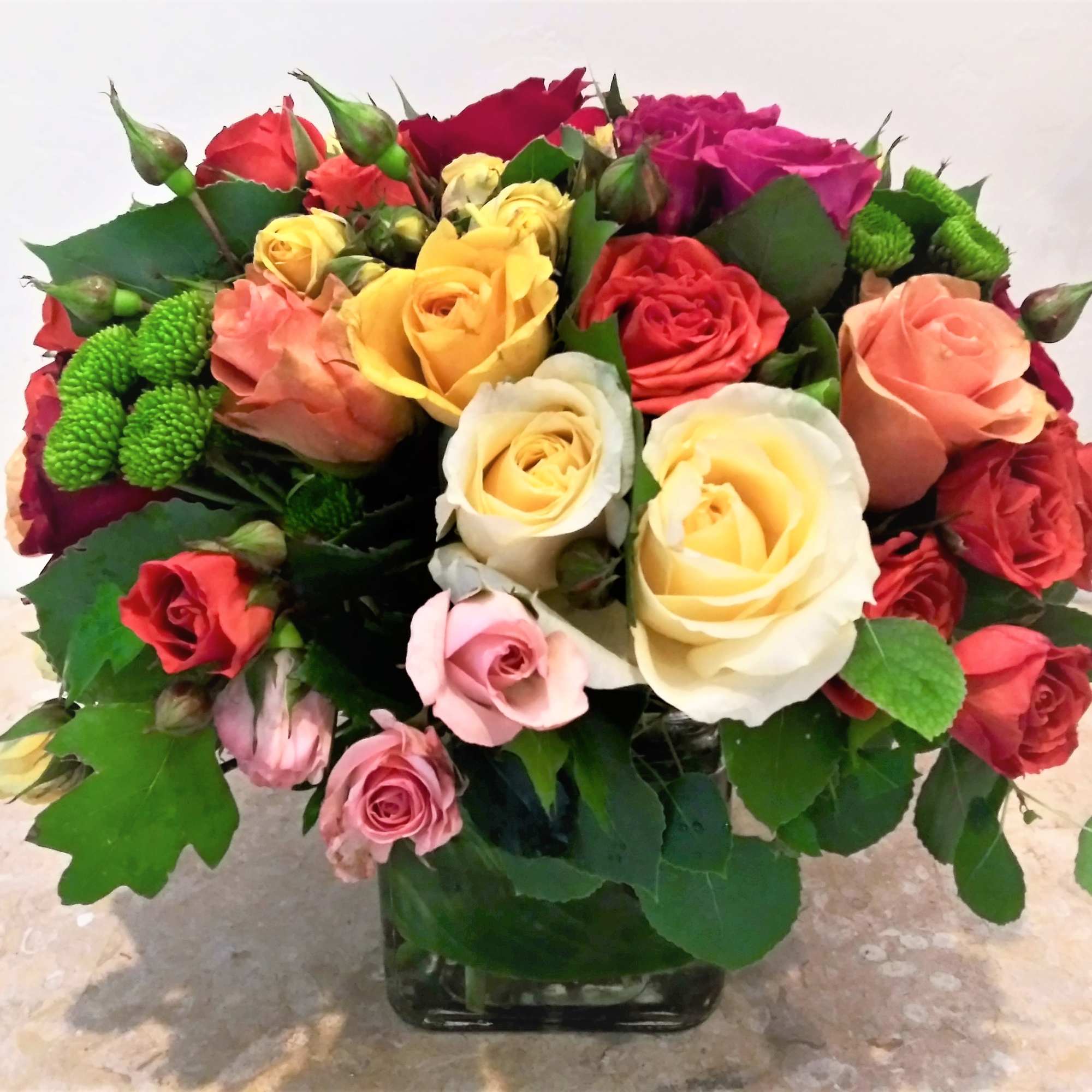 A full-color explosion, Kaleidoscope fresh floral arrangement is a beautiful gift for