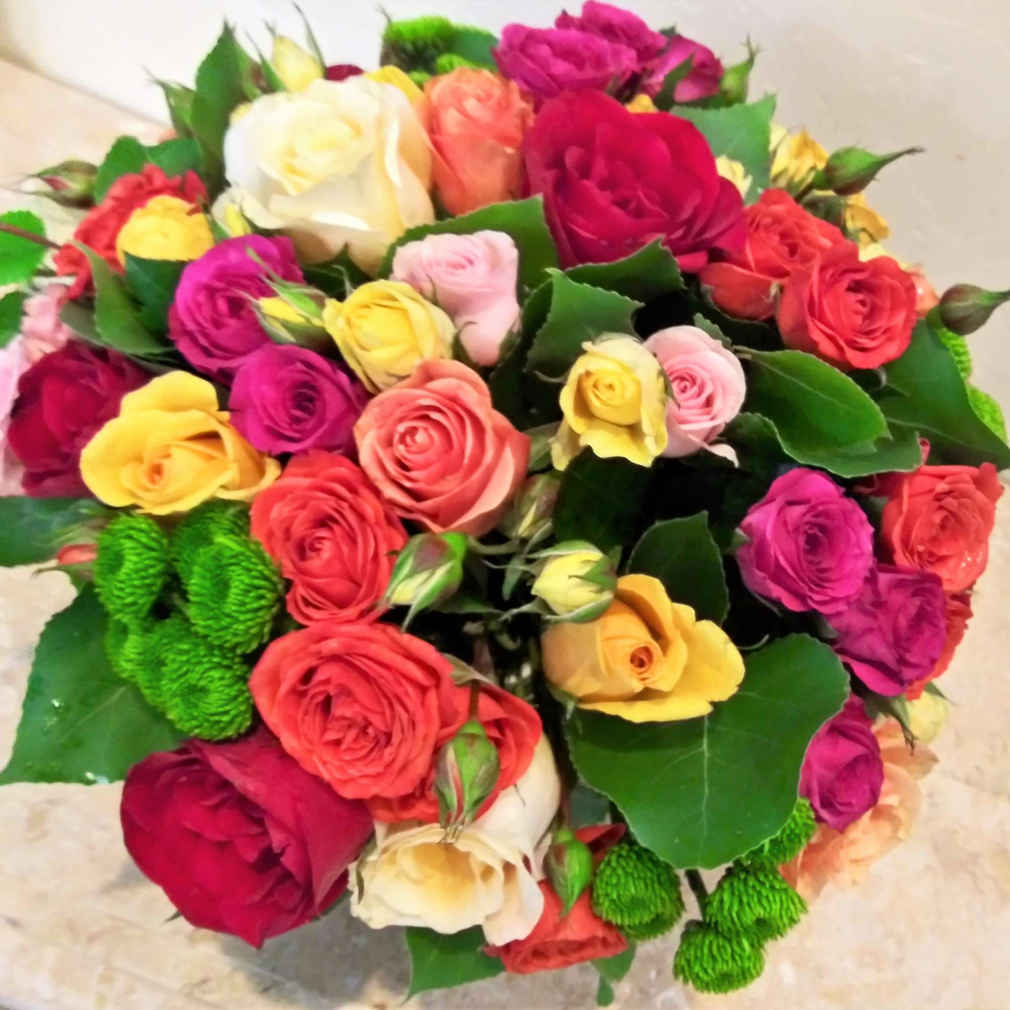 A full-color explosion, Kaleidoscope fresh floral arrangement is a beautiful gift for
