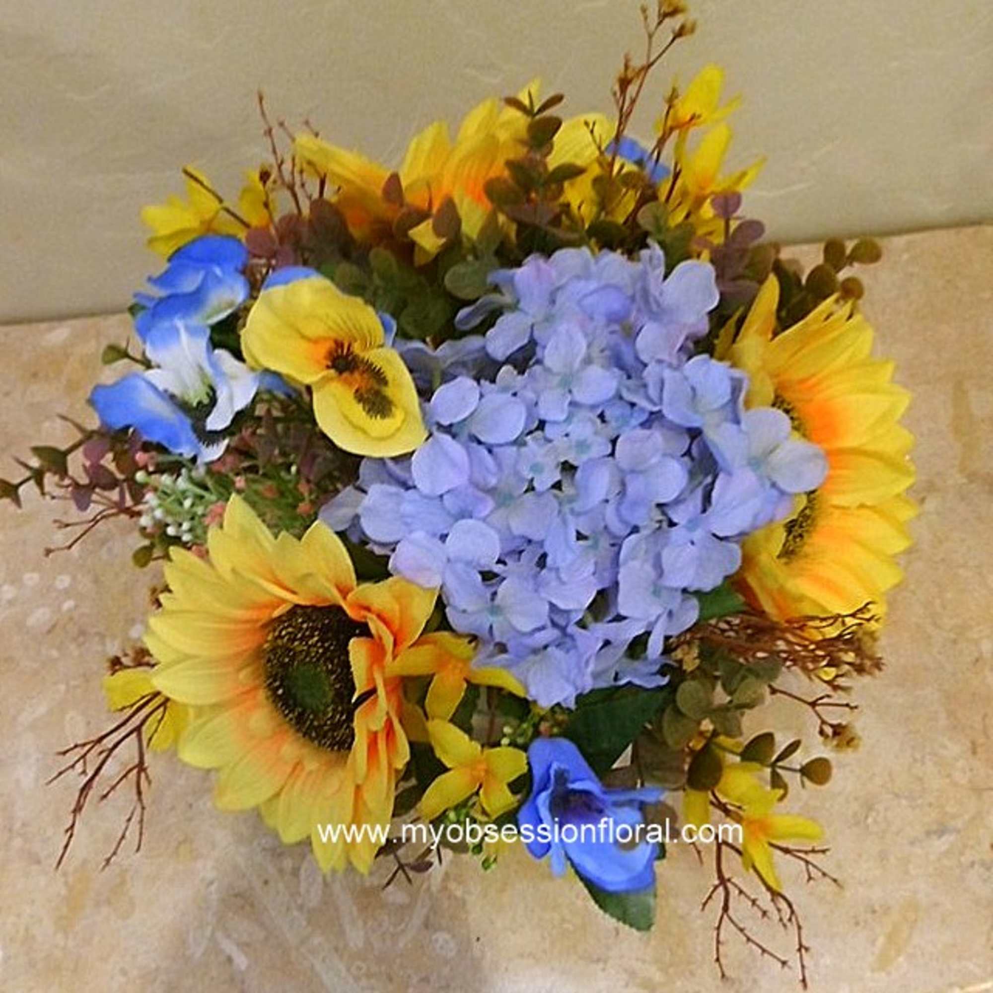 Bouquet of blue hydrangeas and yellow sunflowers
