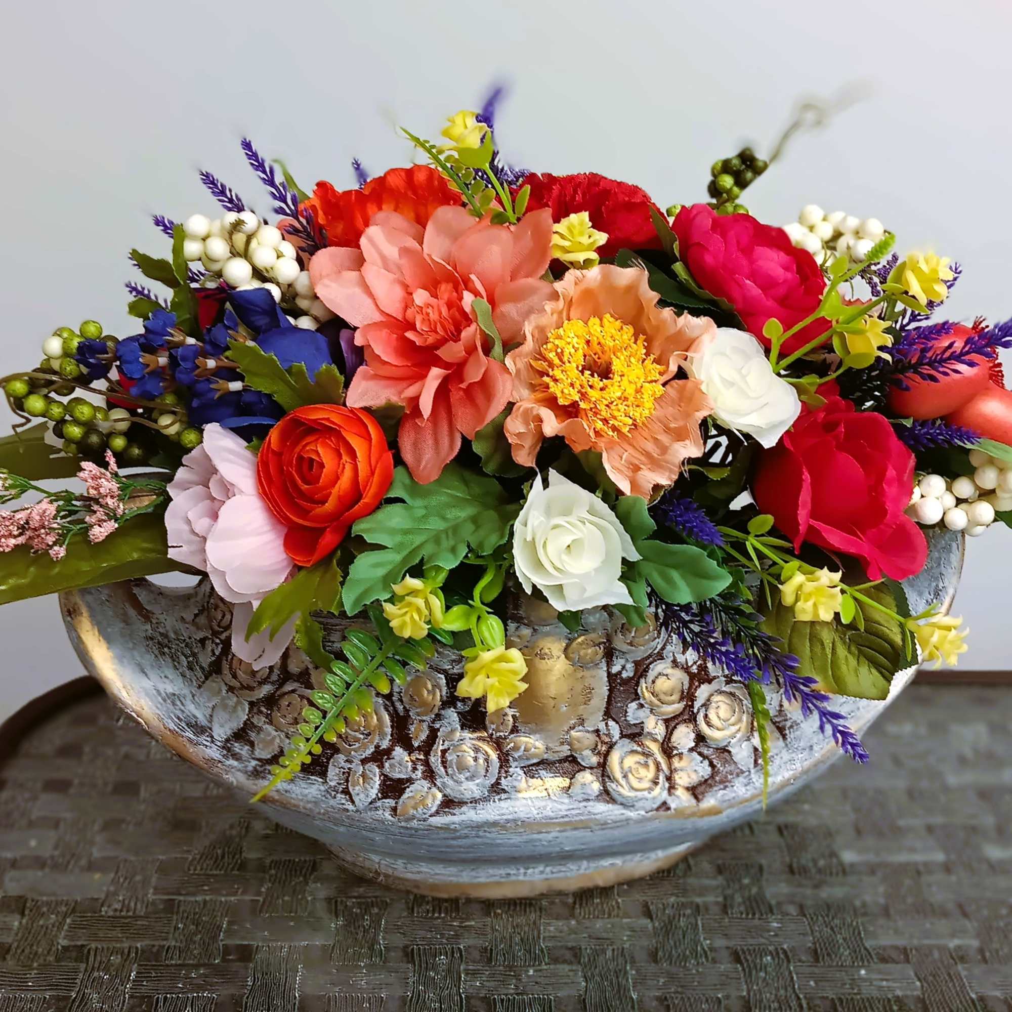 Colorful mixed flower arrangement in a decorative ceramic bowl