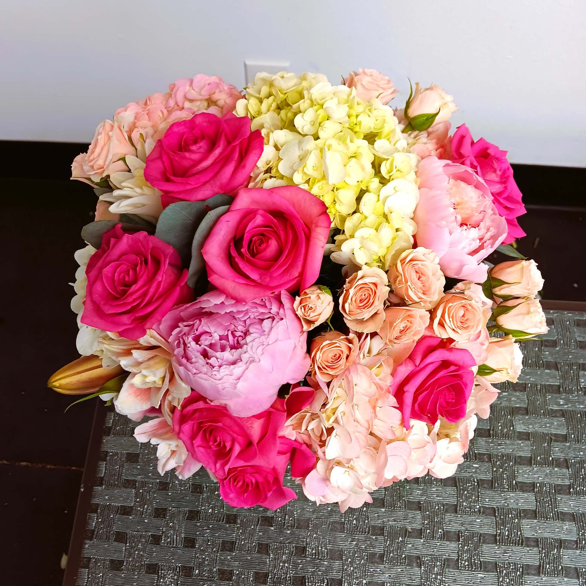 Bouquet of pink roses, peonies, and hydrangeas
