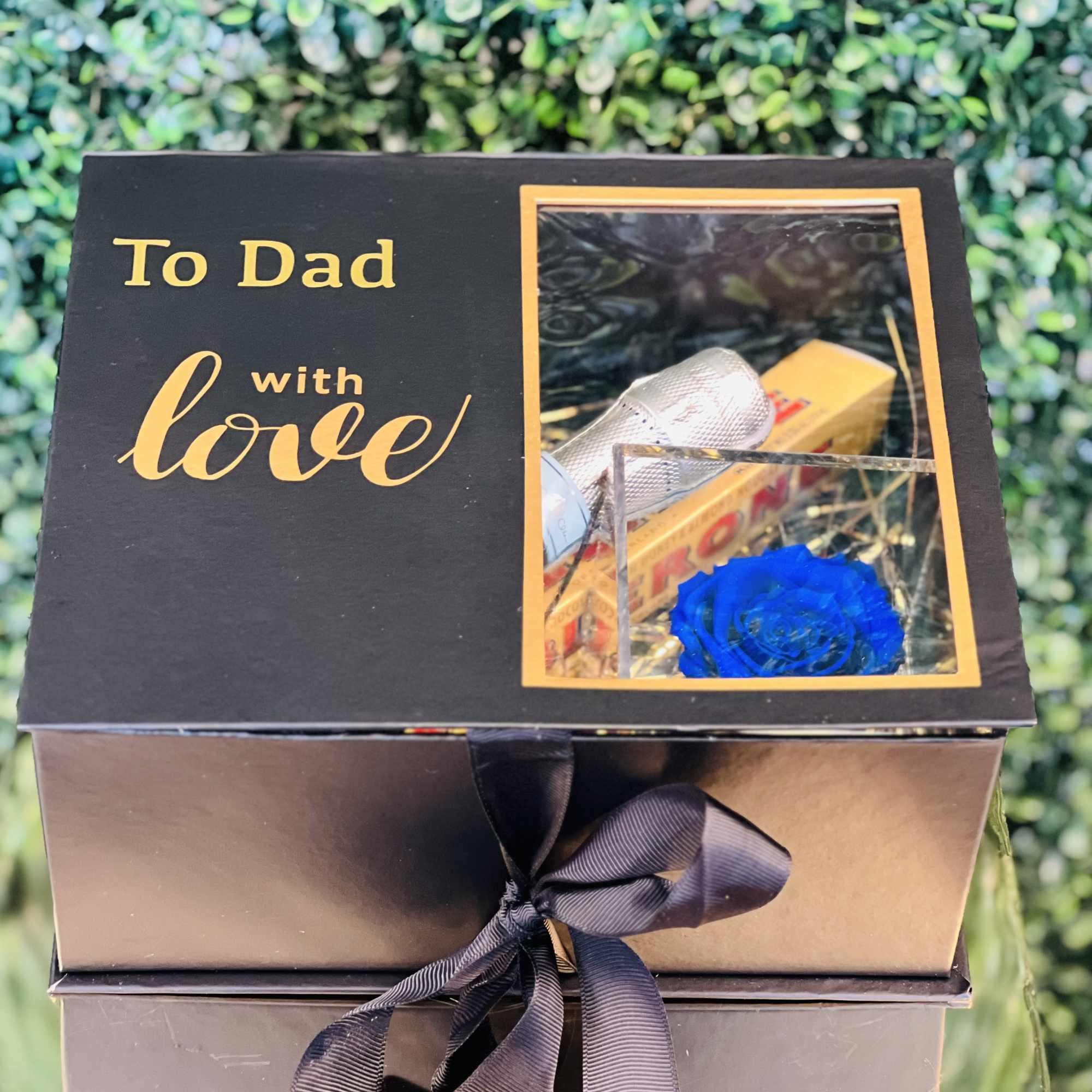 Gift box with a blue rose and a "To Dad with love" card