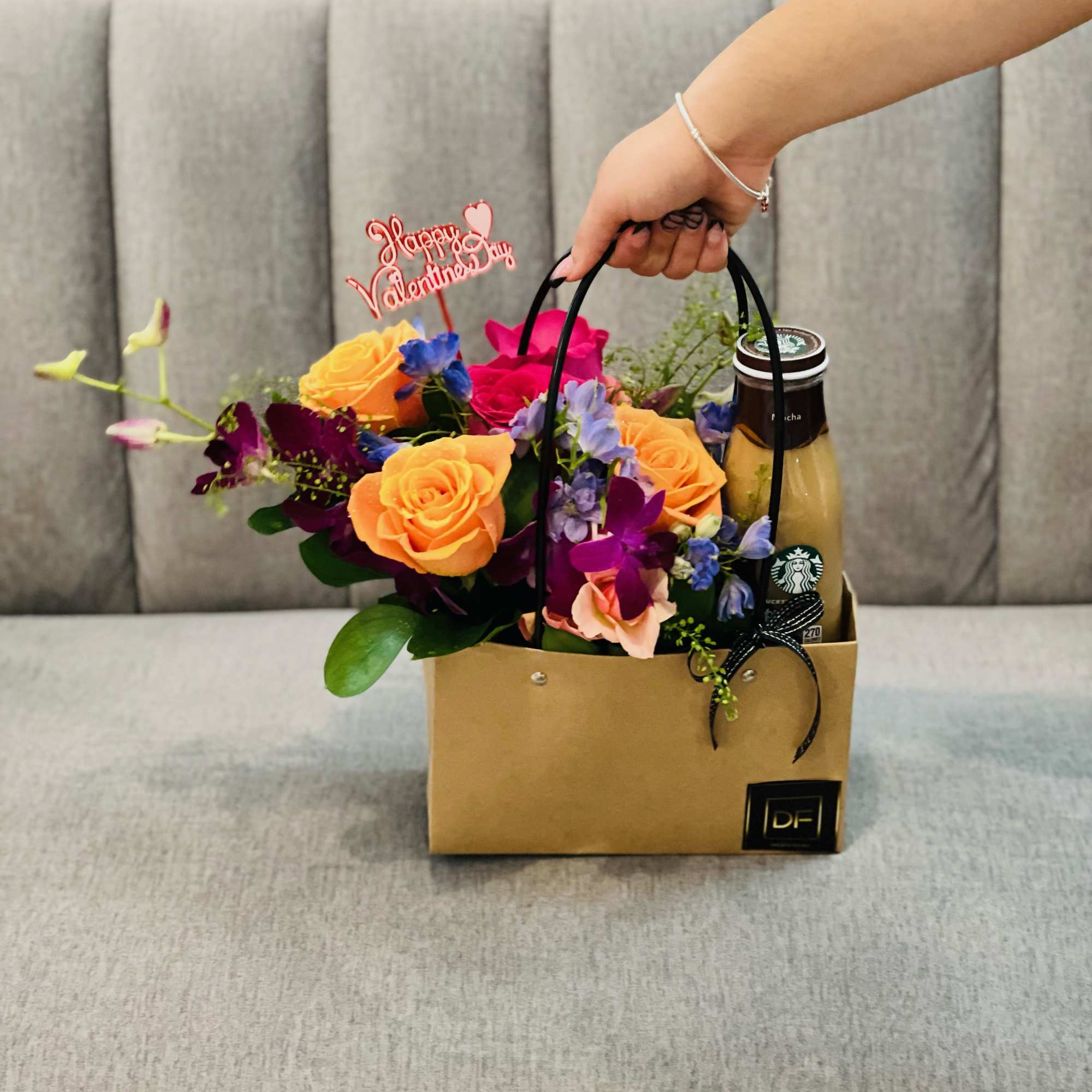 Flower gift bag with roses and a drink bottle