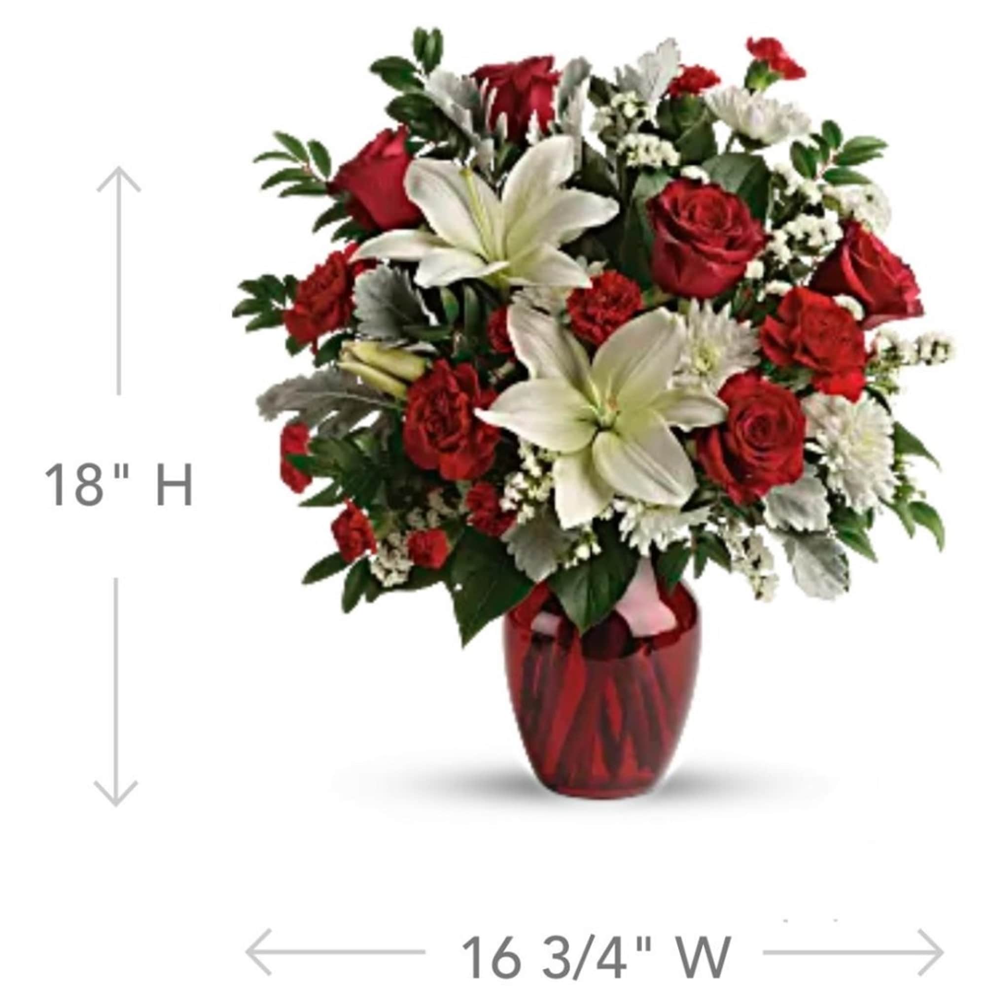 Red roses and white lilies in a red glass vase, photo 2 of 5