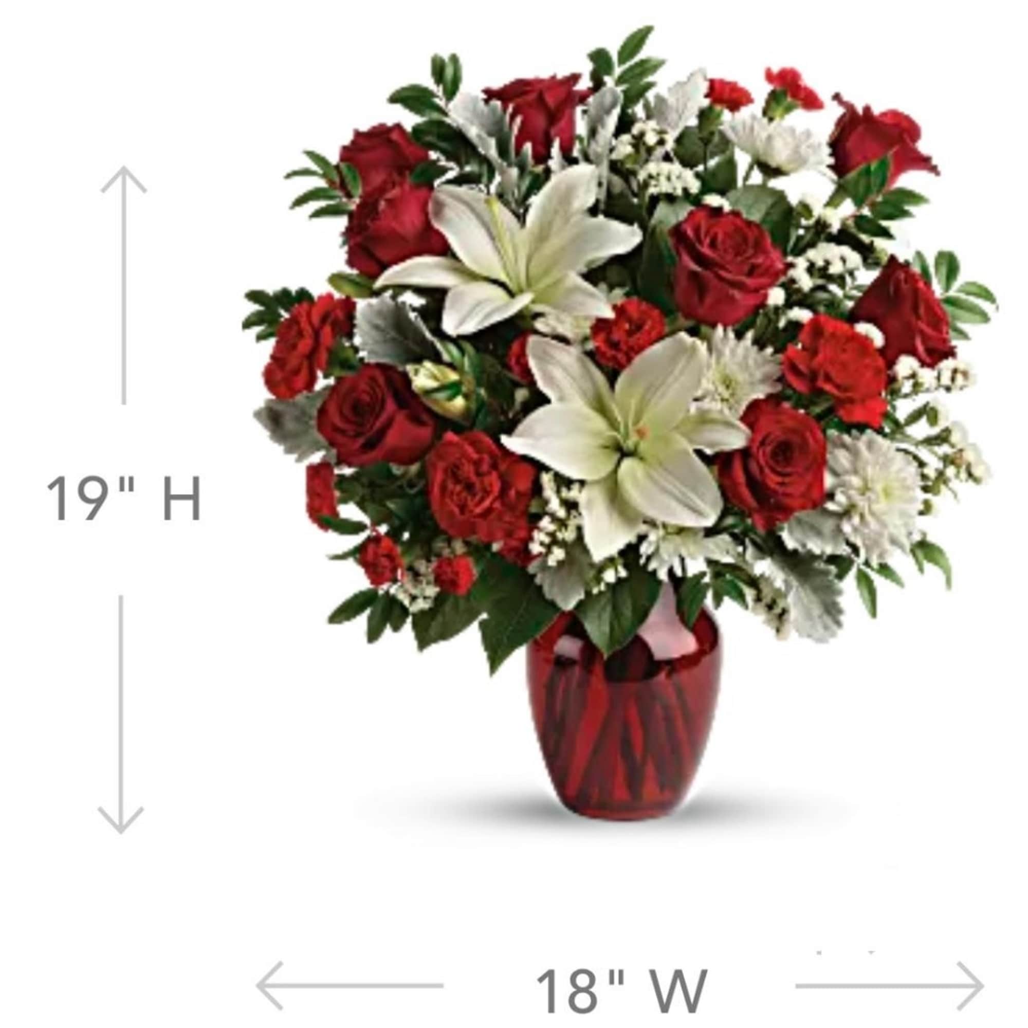 Red roses and white lilies arranged in a red vase