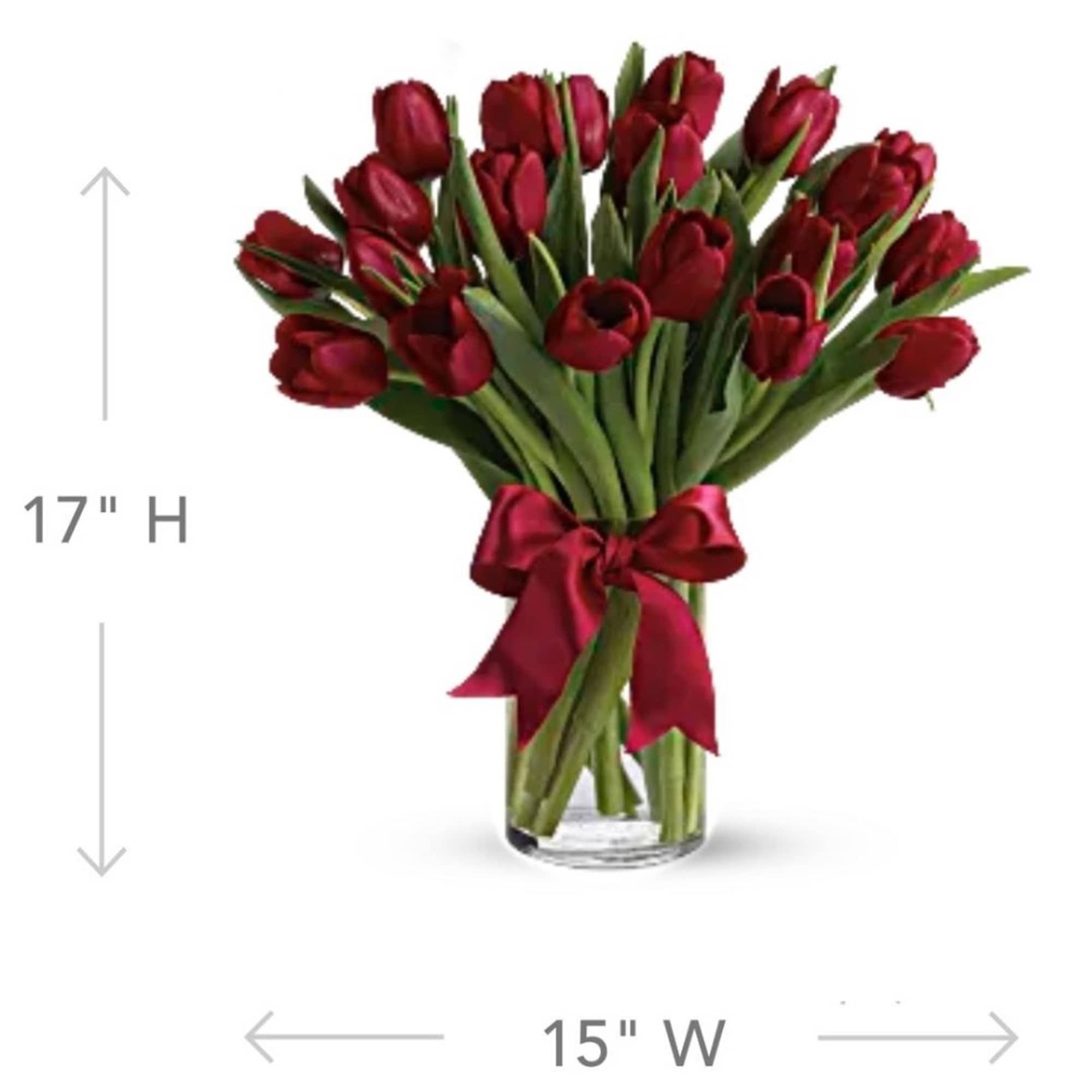 Bouquet of red tulips tied with a red ribbon in a clear glass vase