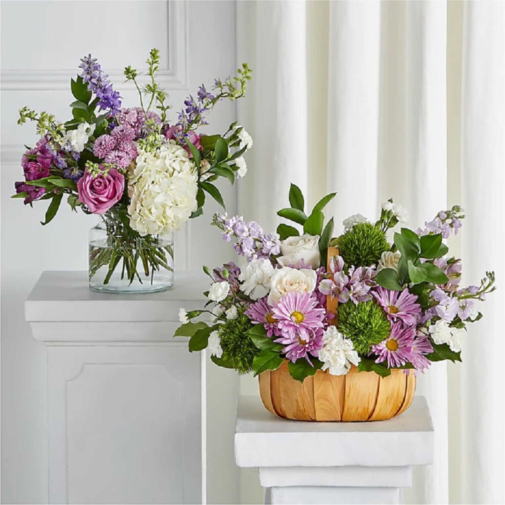 Two mixed flower arrangements, one in a glass vase and one in a wooden basket.
