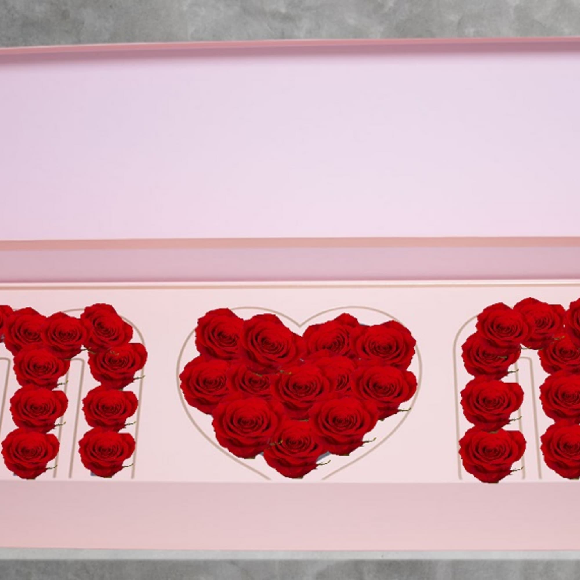 Pink gift box with red roses arranged in the letters M and N and a heart