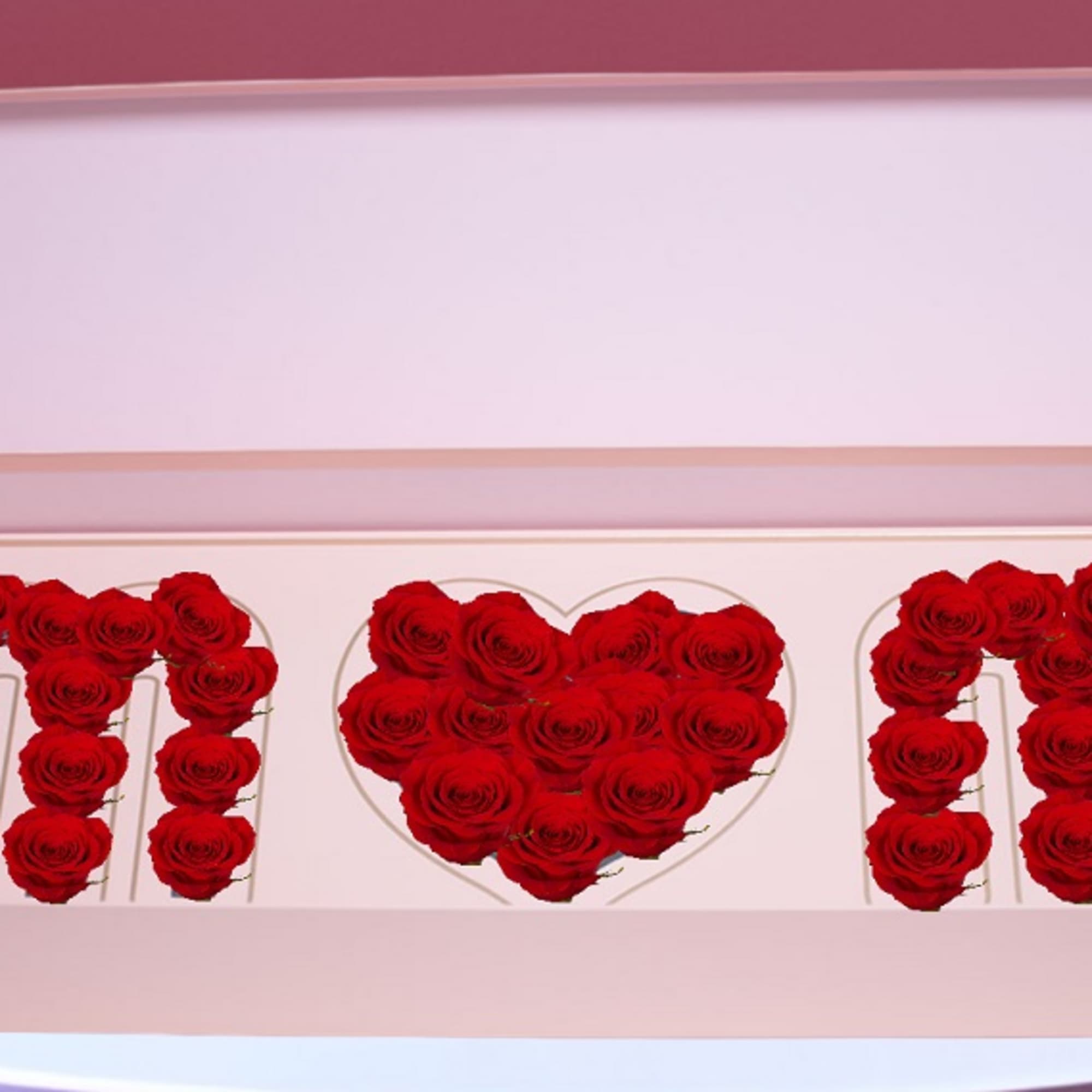Red roses arranged in a pink heart-shaped gift box