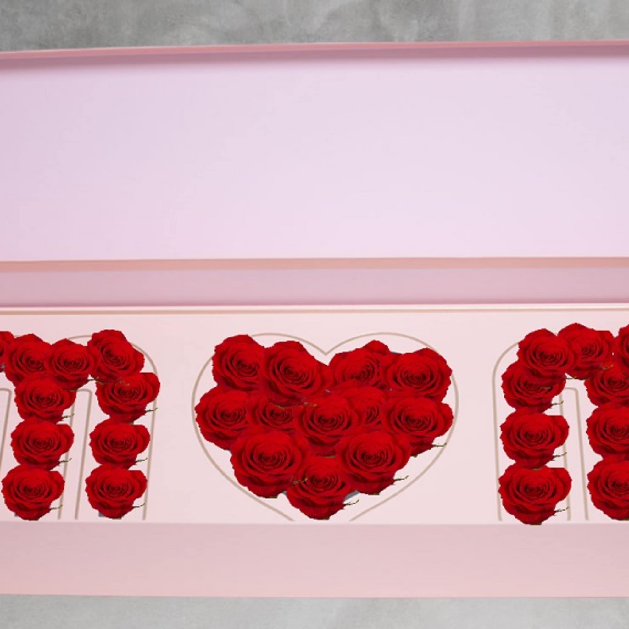 Pink gift box with red roses arranged in letters and a heart
