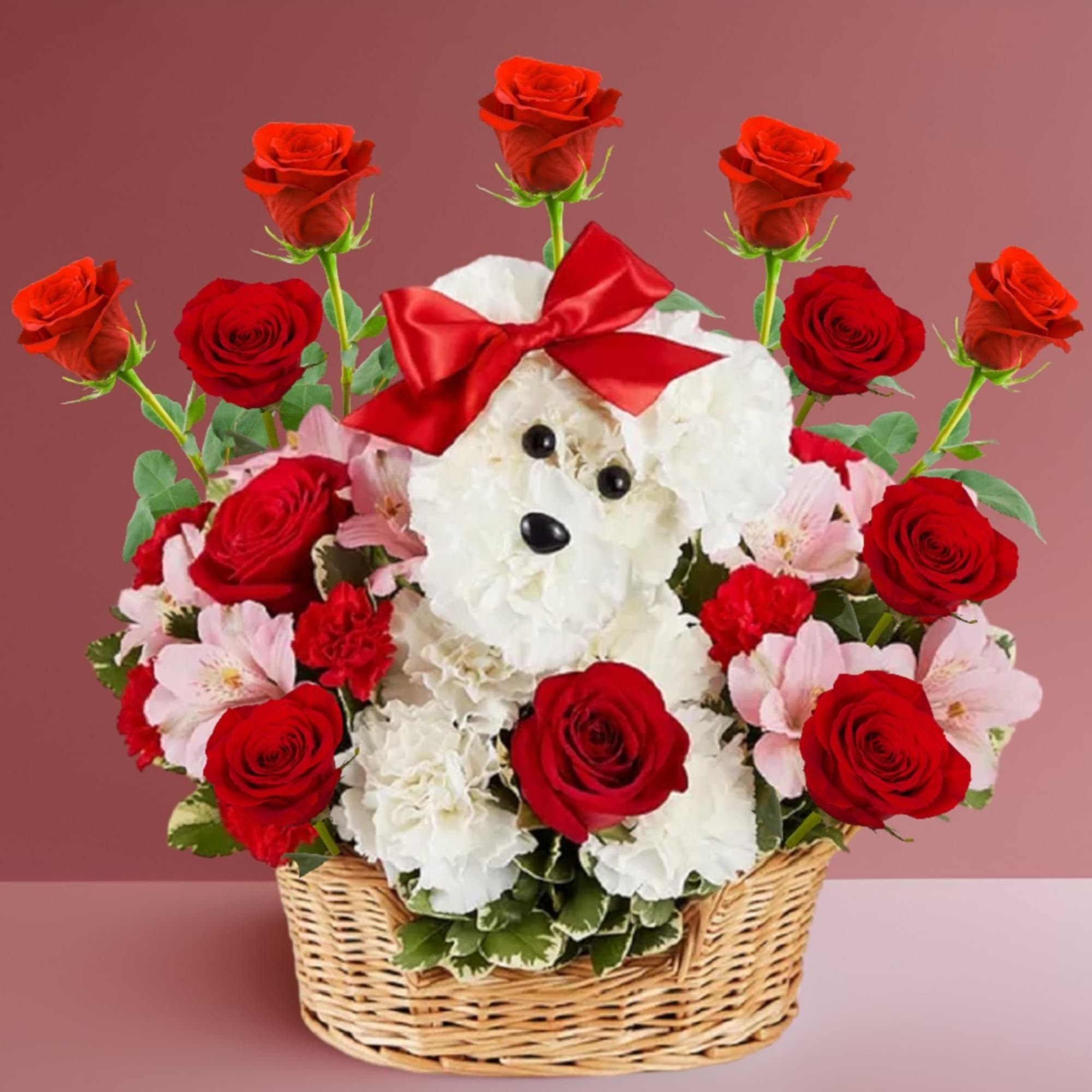 Basket arrangement with red roses and a white teddy bear topped with a red bow