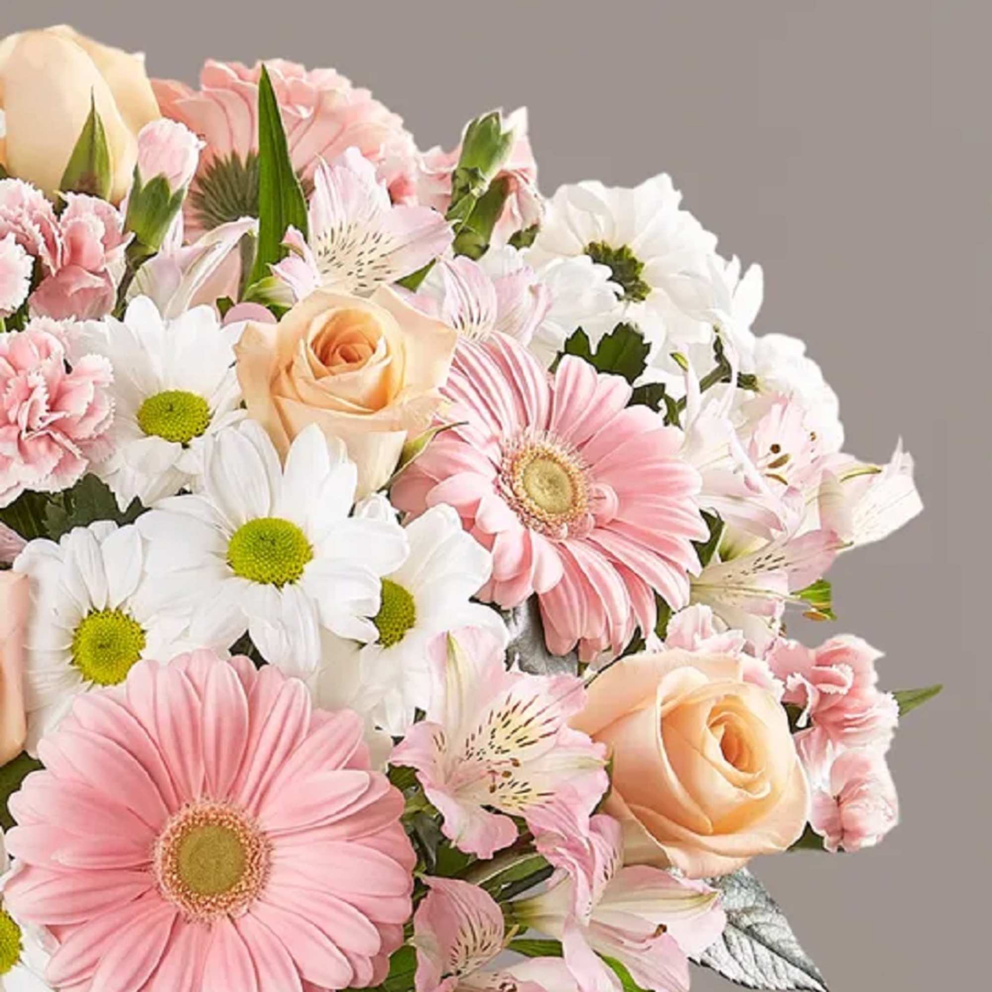 Bouquet of pink gerbera daisies, peach roses, and white daisies