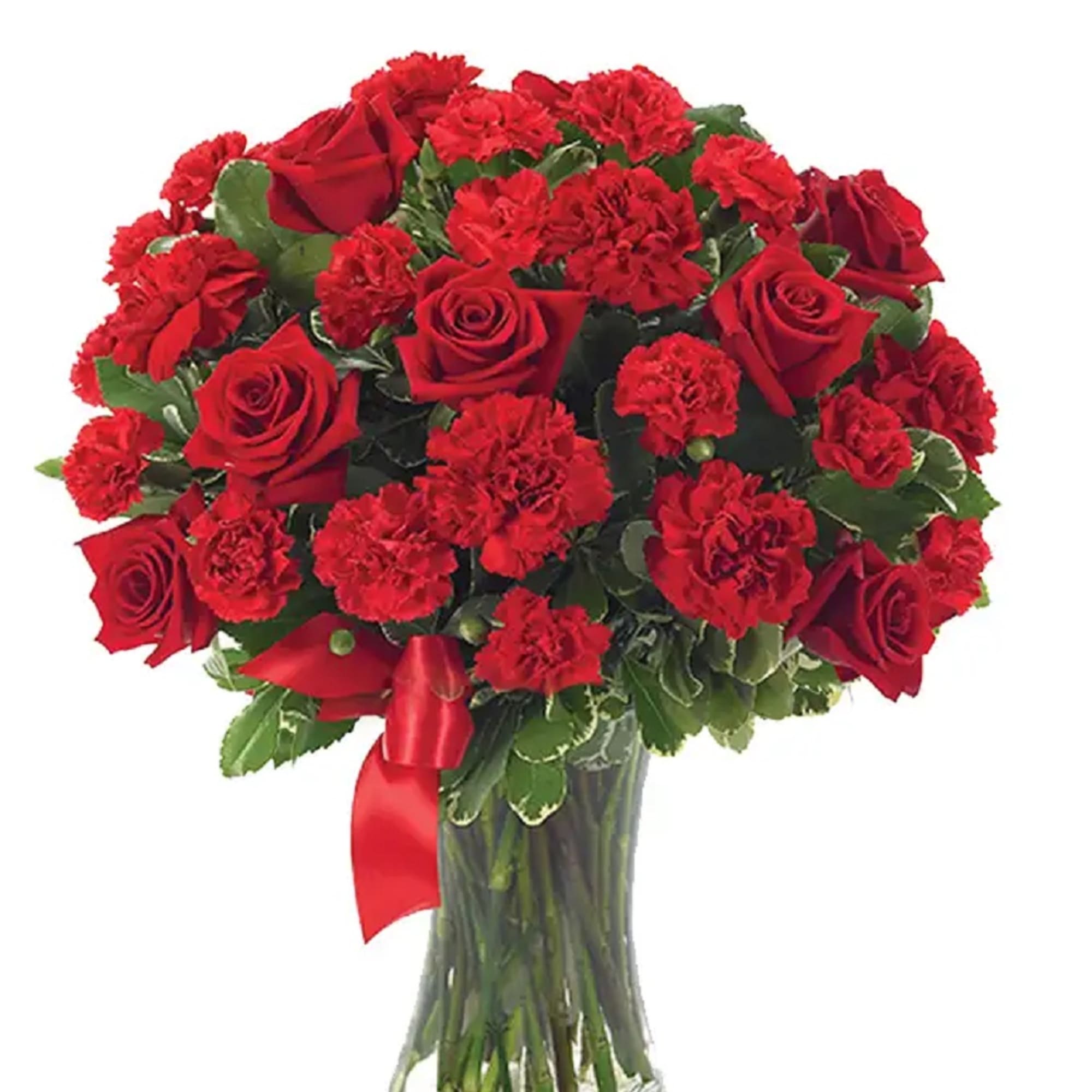 Red roses and carnations arranged in a clear glass vase with a red ribbon