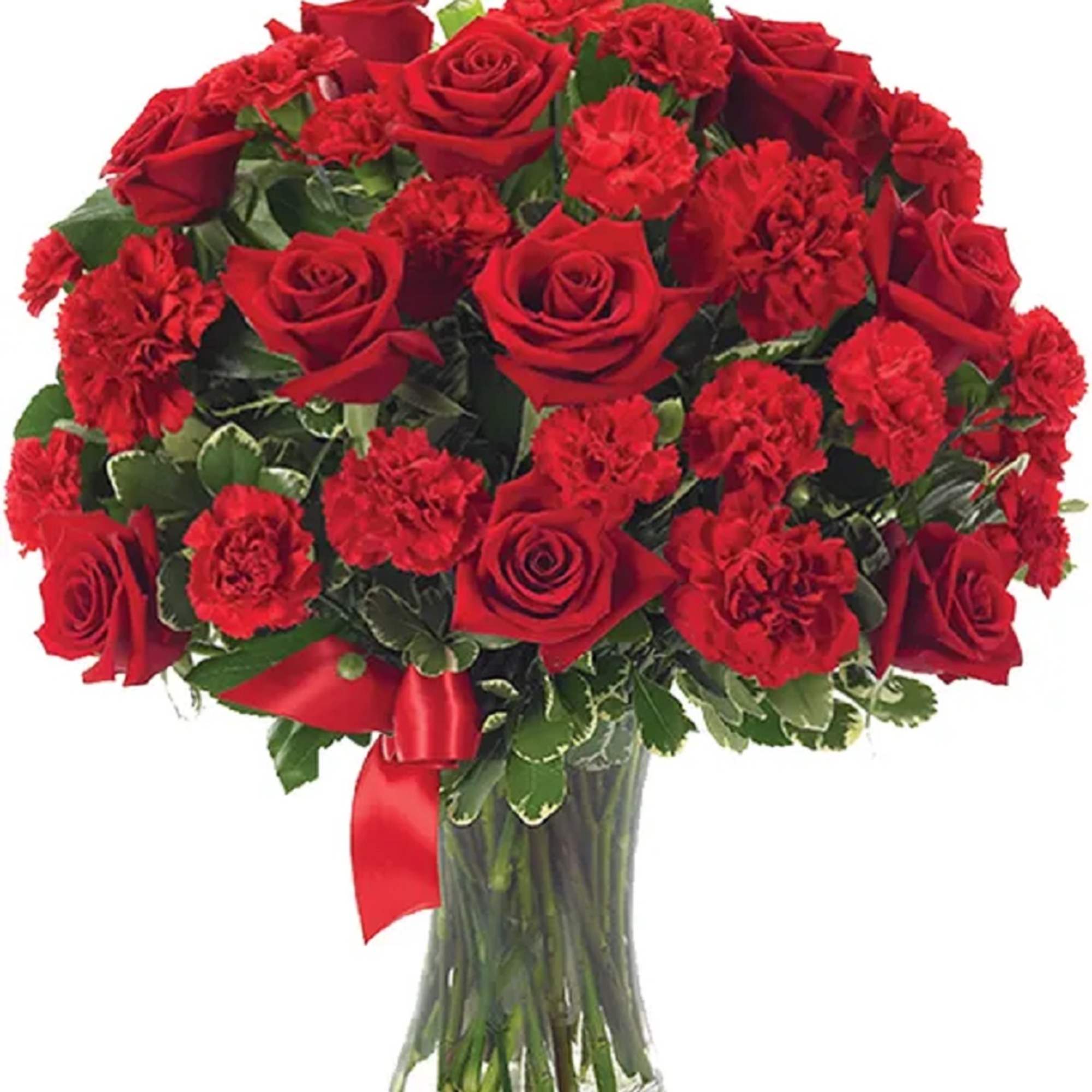 Red roses and carnations in a clear glass vase with a red ribbon