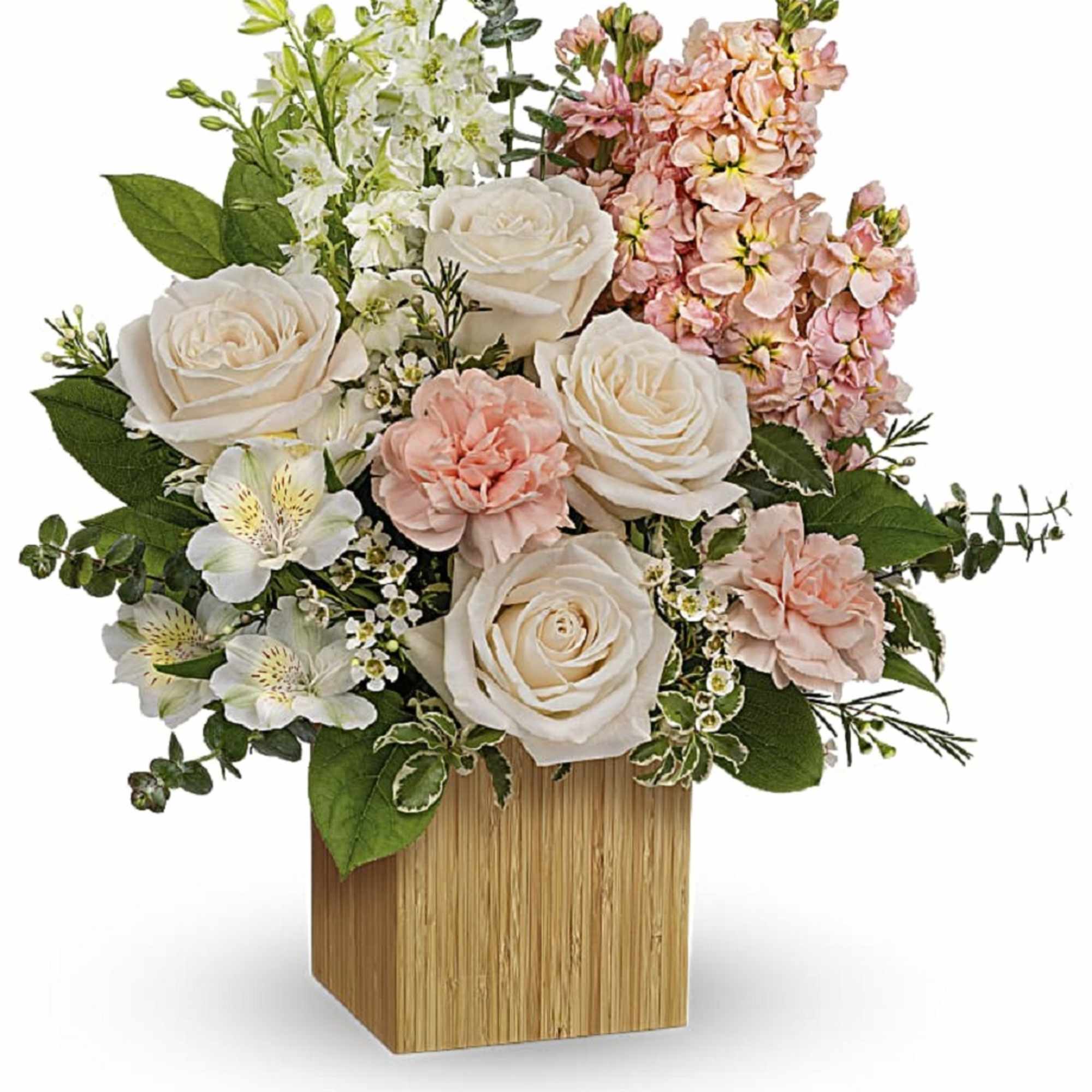 Pink and white floral arrangement in a wooden cube vase