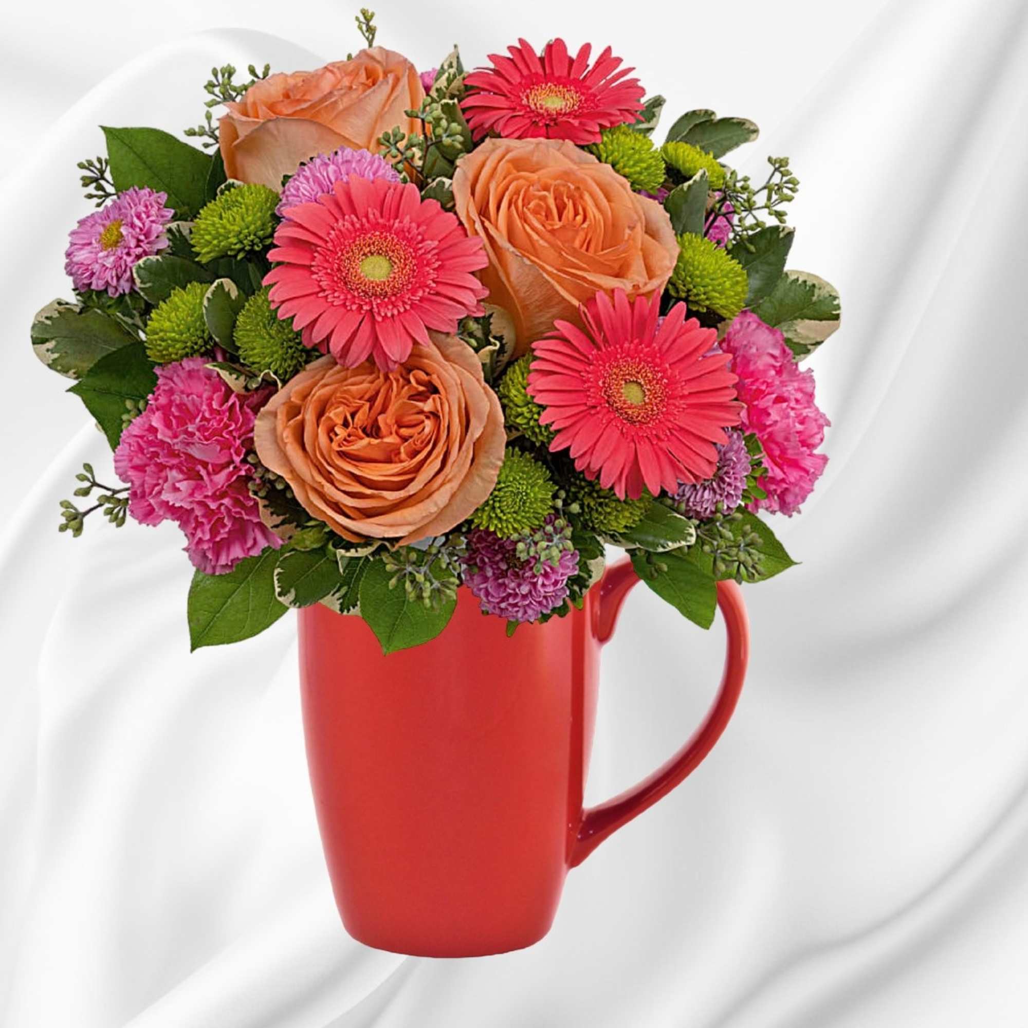 Bouquet of orange roses, pink gerberas, and carnations in a red mug