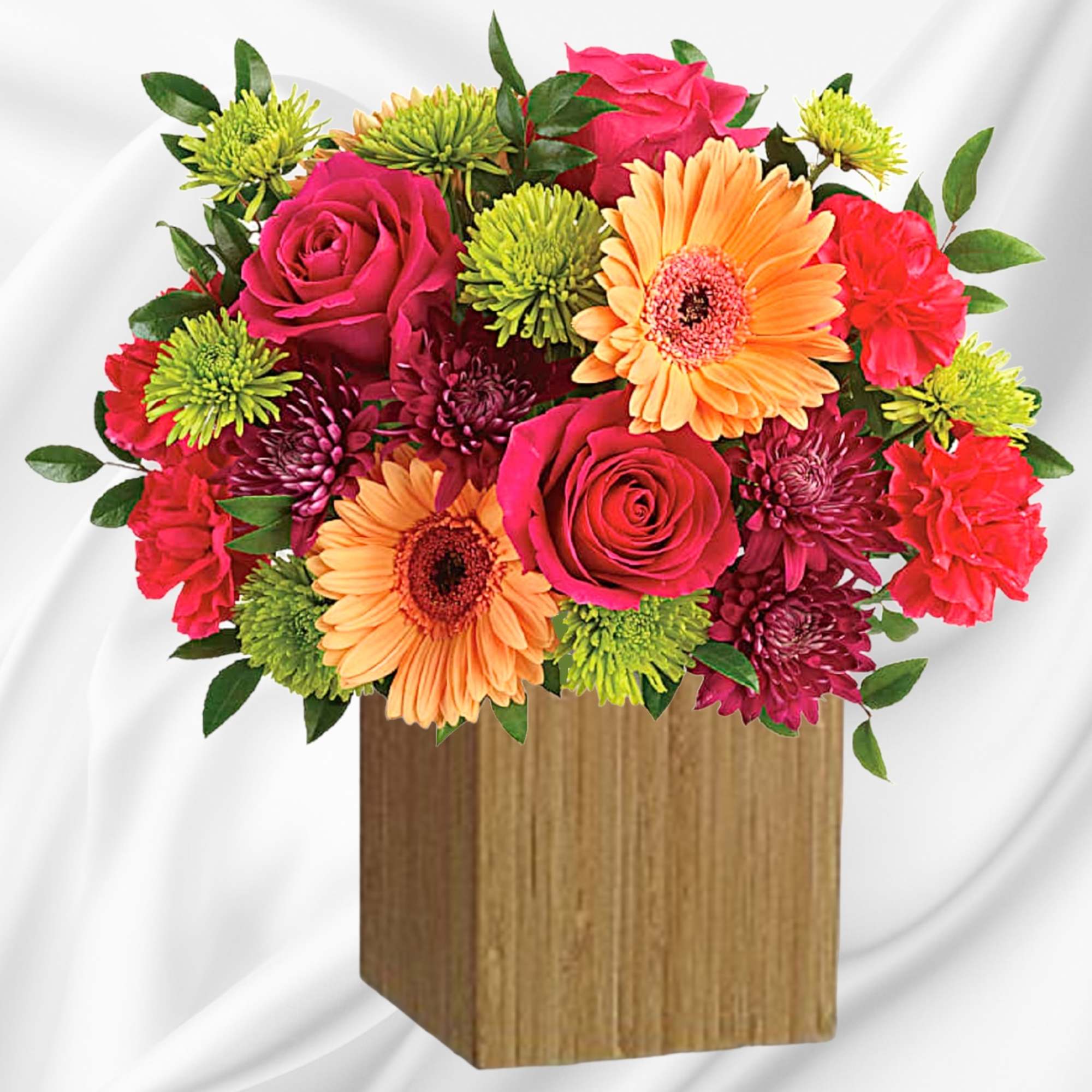 Mixed bouquet of roses, gerbera daisies, chrysanthemums, and carnations in a wooden vase