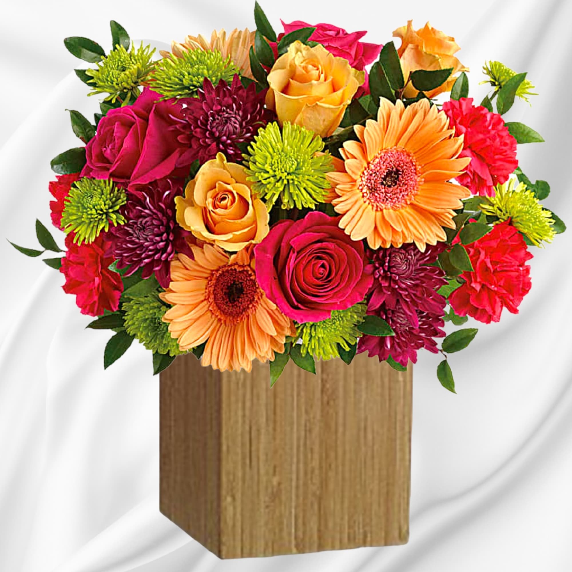 Mixed bouquet of roses, gerbera daisies, and chrysanthemums in a wooden box